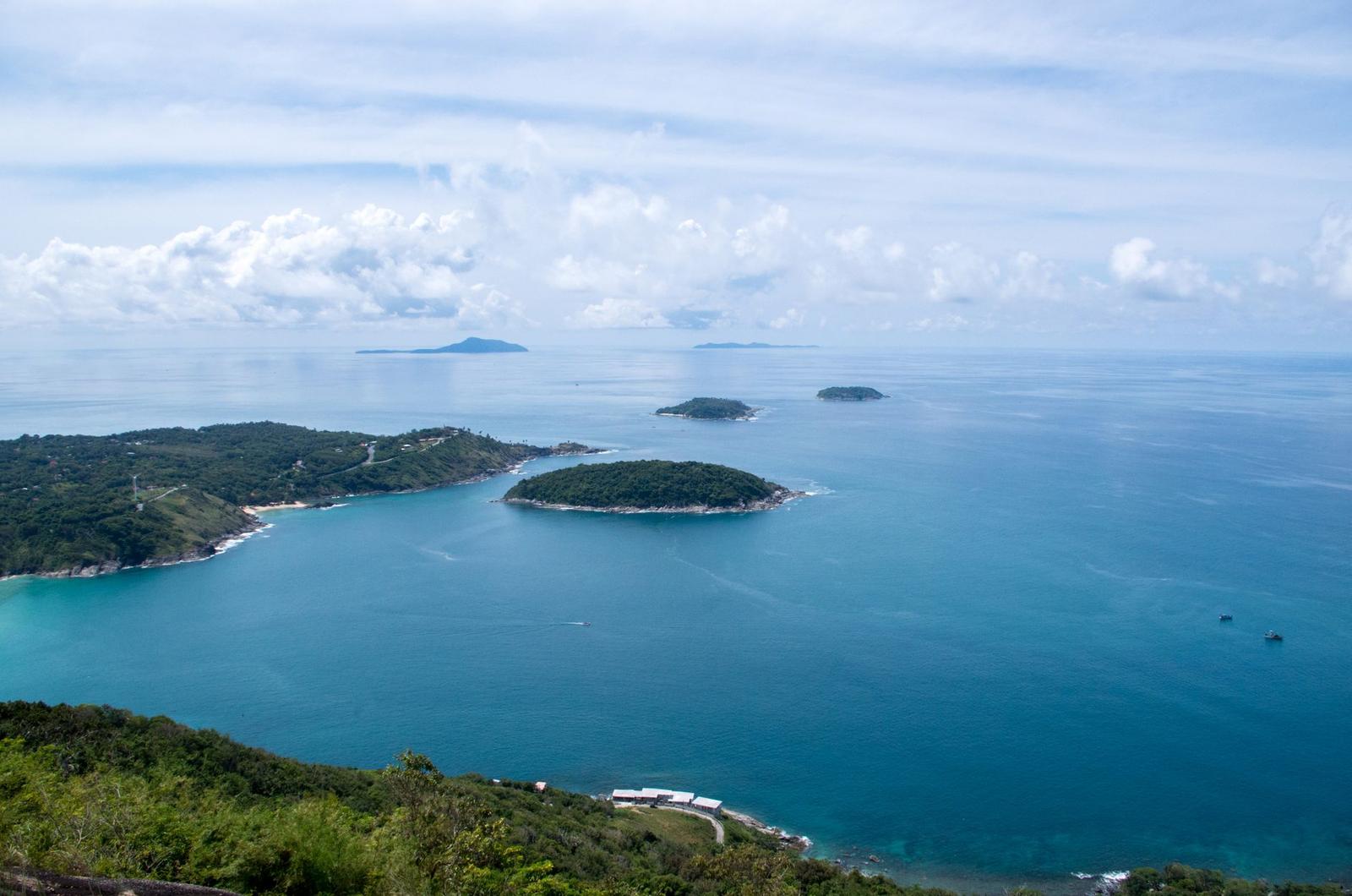 Elevated view of forested headlands scattered across a turquoise bay