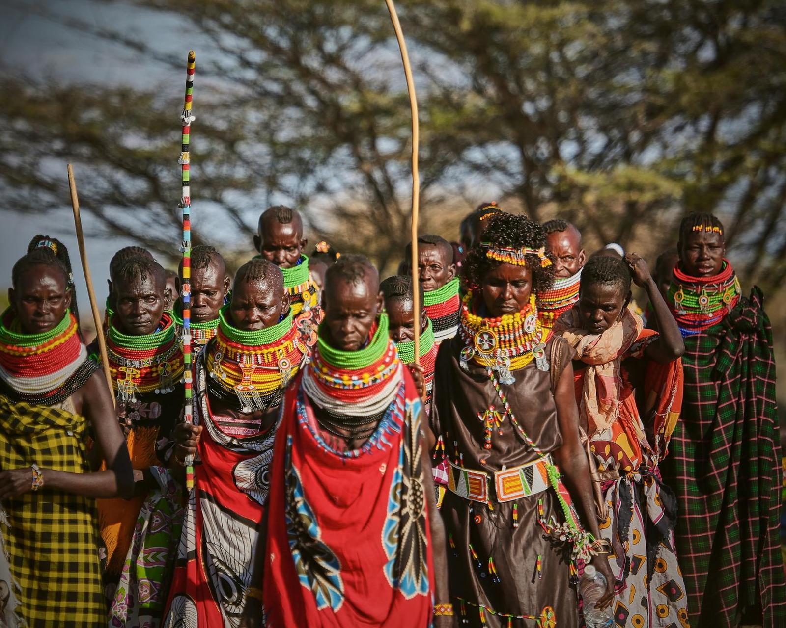 Maasai women in beaded collars and headdresses standing close together
