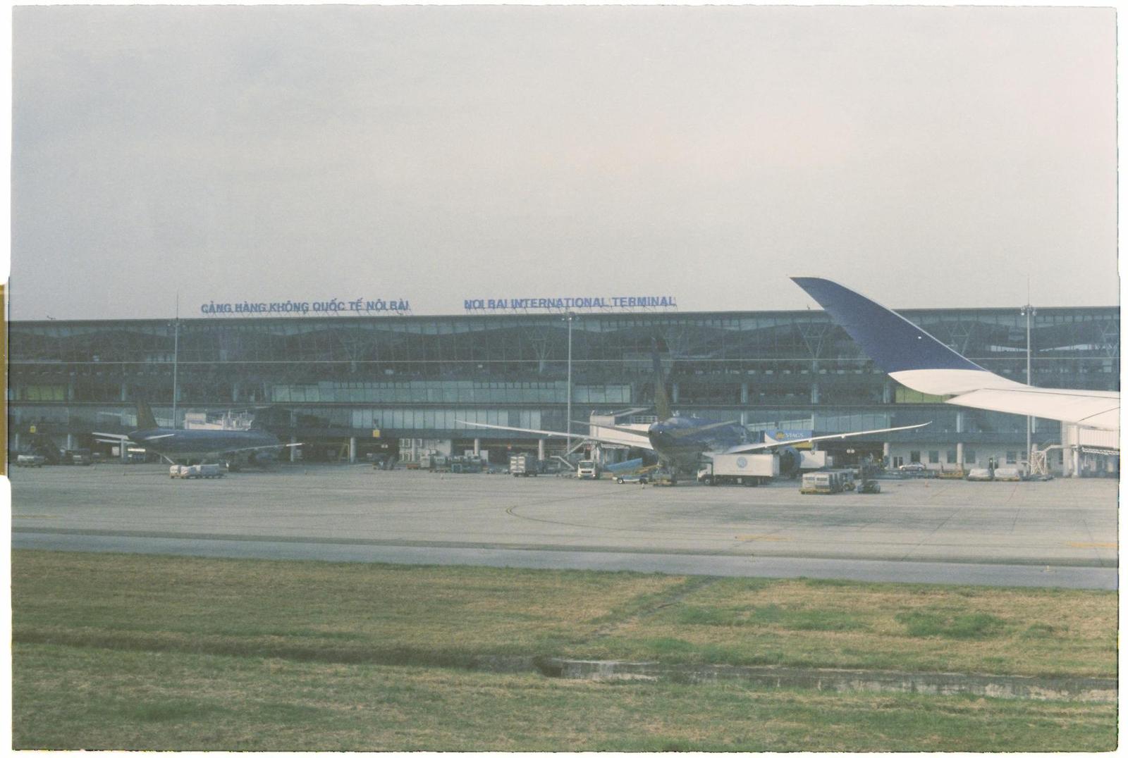 An airliner parked on the tarmac beside a low airport terminal building