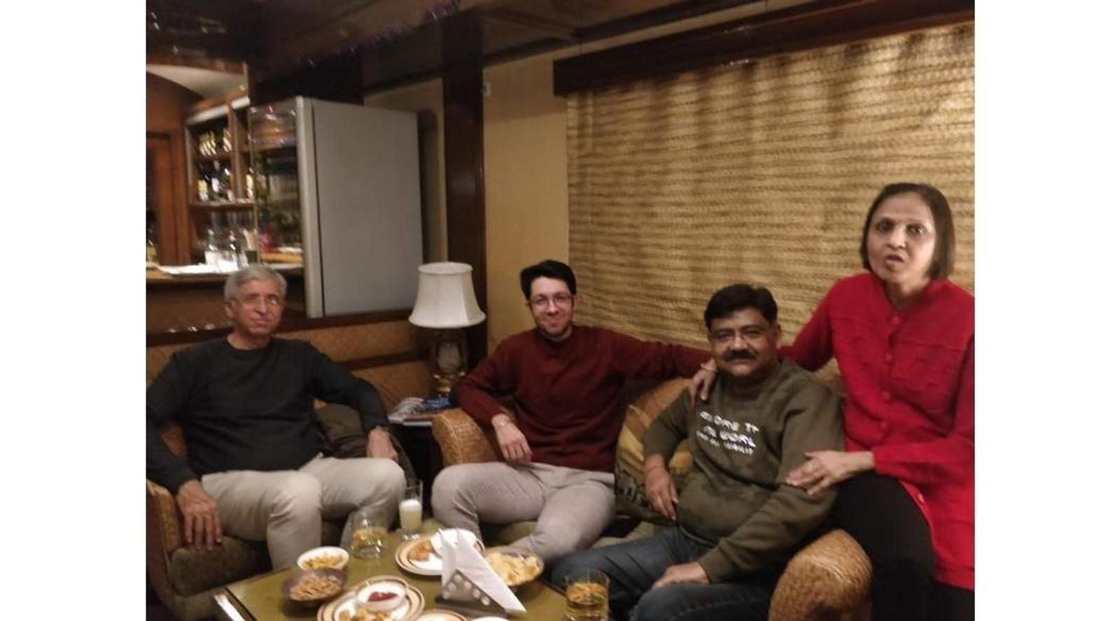 Four people seated on a sofa 