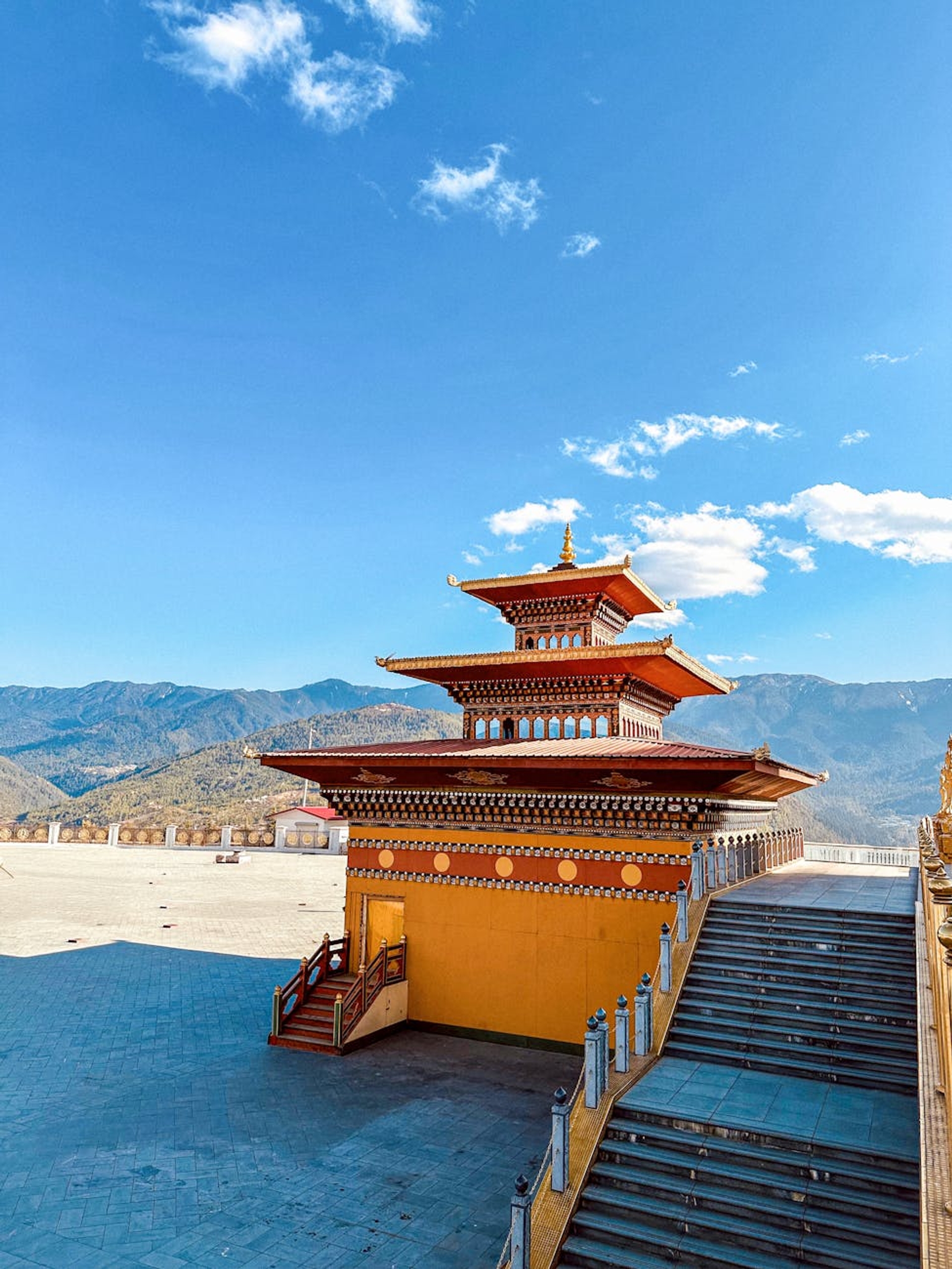 Explore the serene beauty of a Bhutanese temple against the stunning Himalayan backdrop