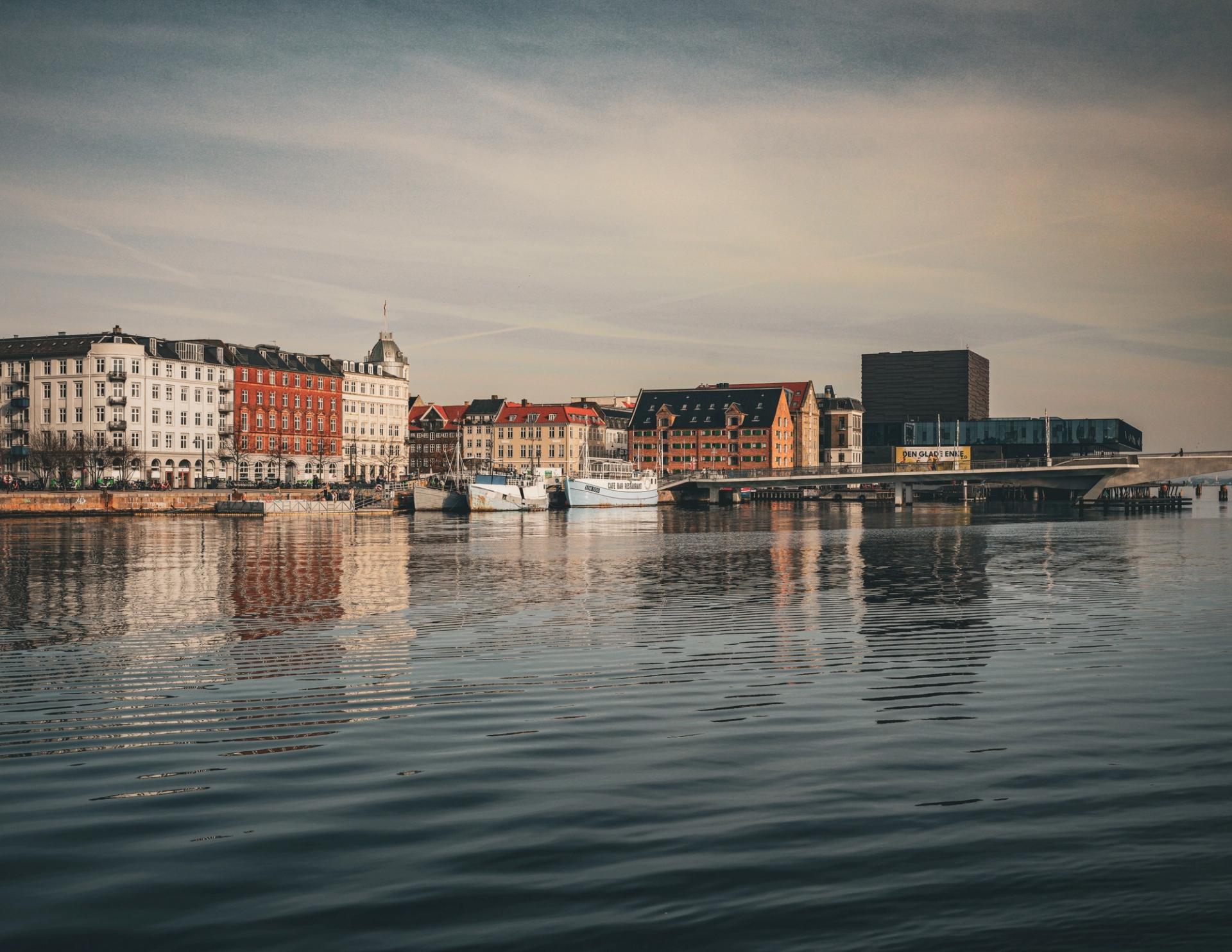 Charming cityscape of Copenhagen with colorful buildings reflecting in the calm water