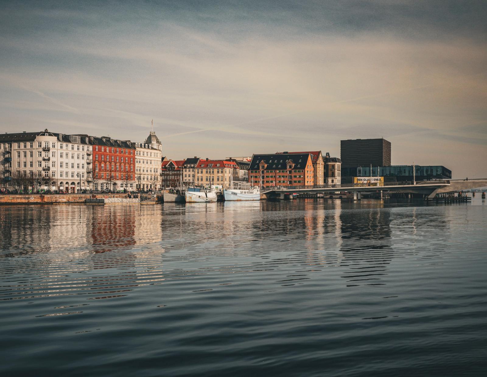 Charming cityscape of Copenhagen with colorful buildings reflecting in the calm water