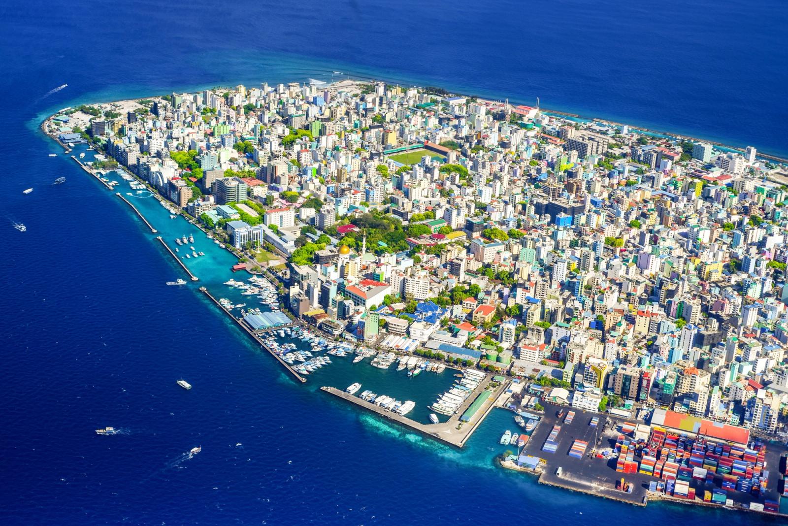 Vibrant aerial view of Malé City, Maldives, showcasing the bustling harbor and vivid cityscape