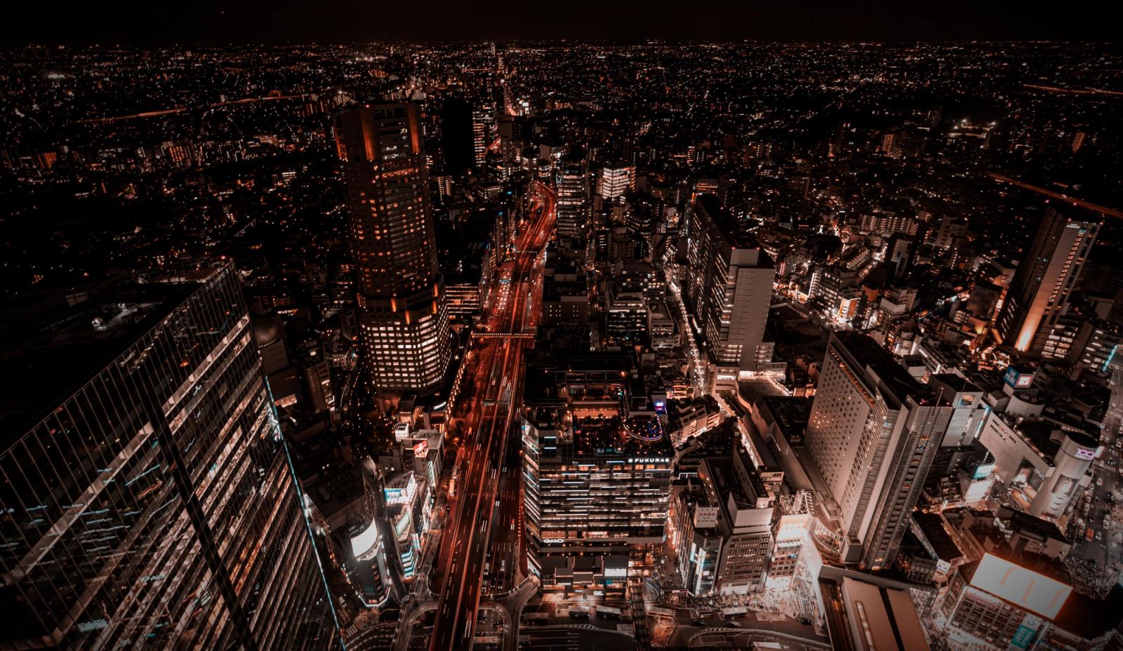 Stunning aerial view of Tokyo's vibrant cityscape at night featuring illuminated skyscrapers and bustling streets