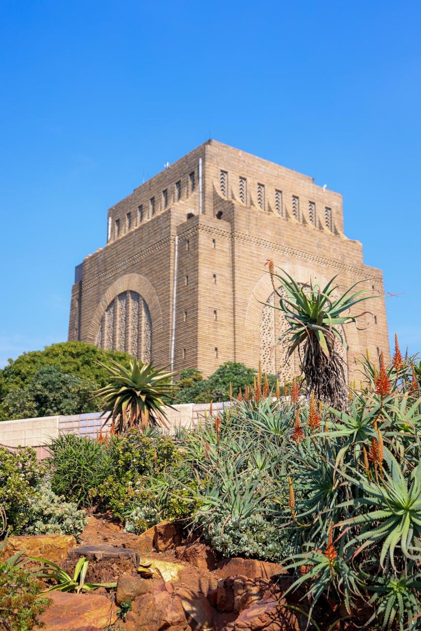 Voortrekker Monument surrounded by lush gardens under a clear blue sky in Pretoria