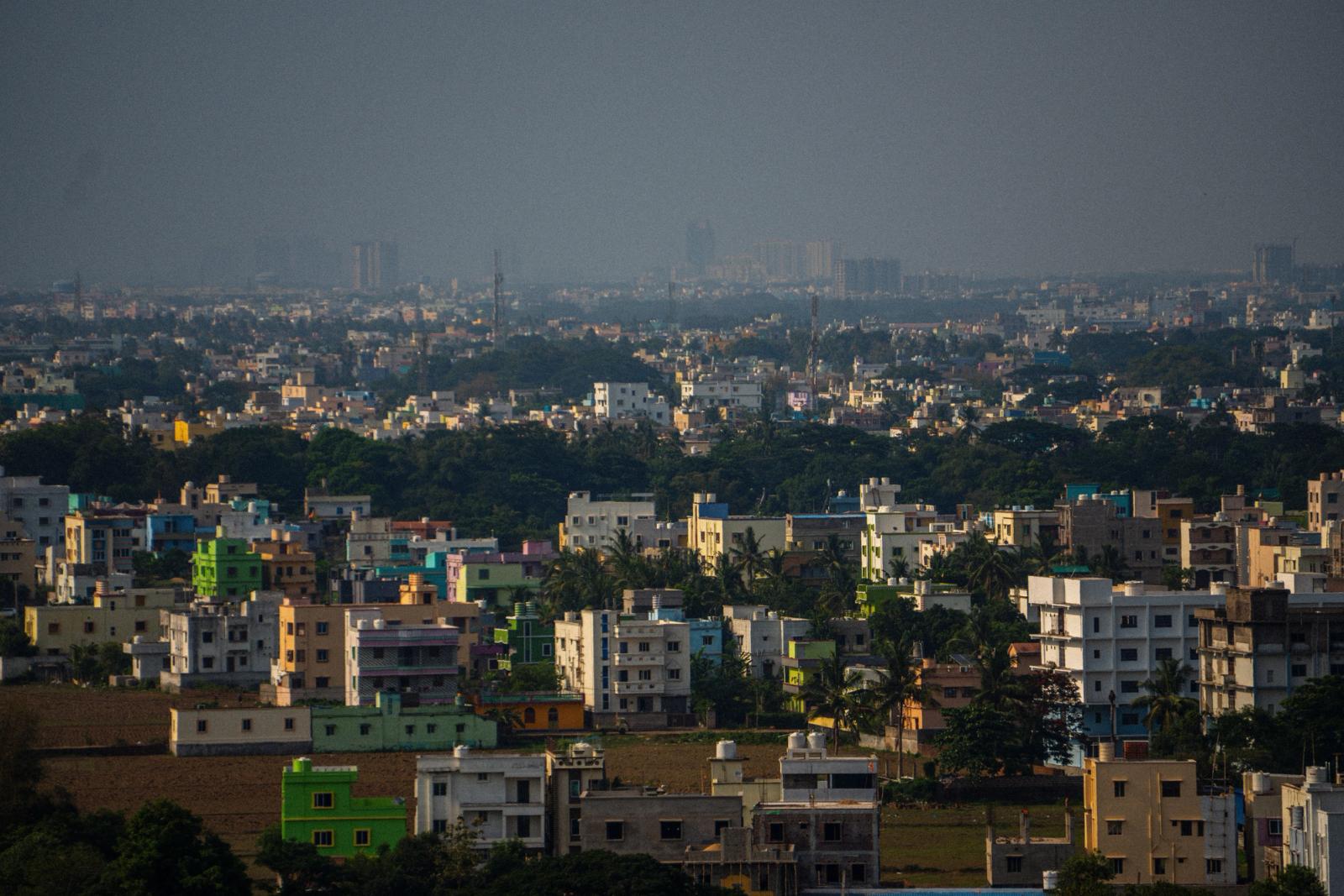 Aerial view of urban buildings and lush greenery in Bhubaneswar, India, showcasing vibrant architecture and dense population