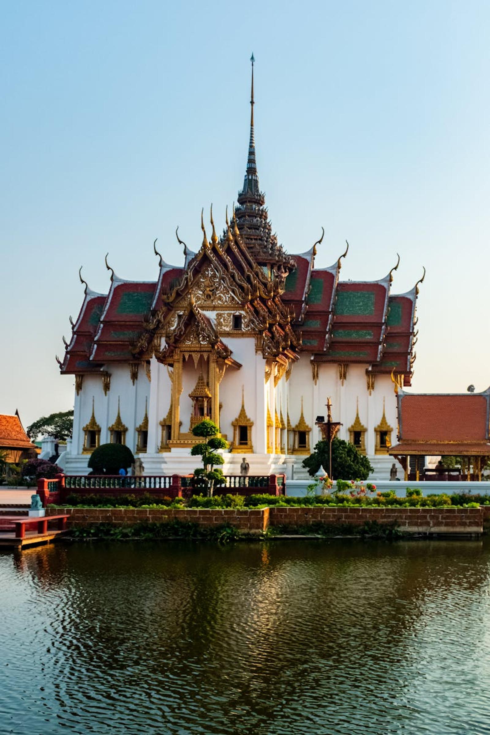 Serene view of a traditional Thai temple reflecting on a calm lake in Bangkok