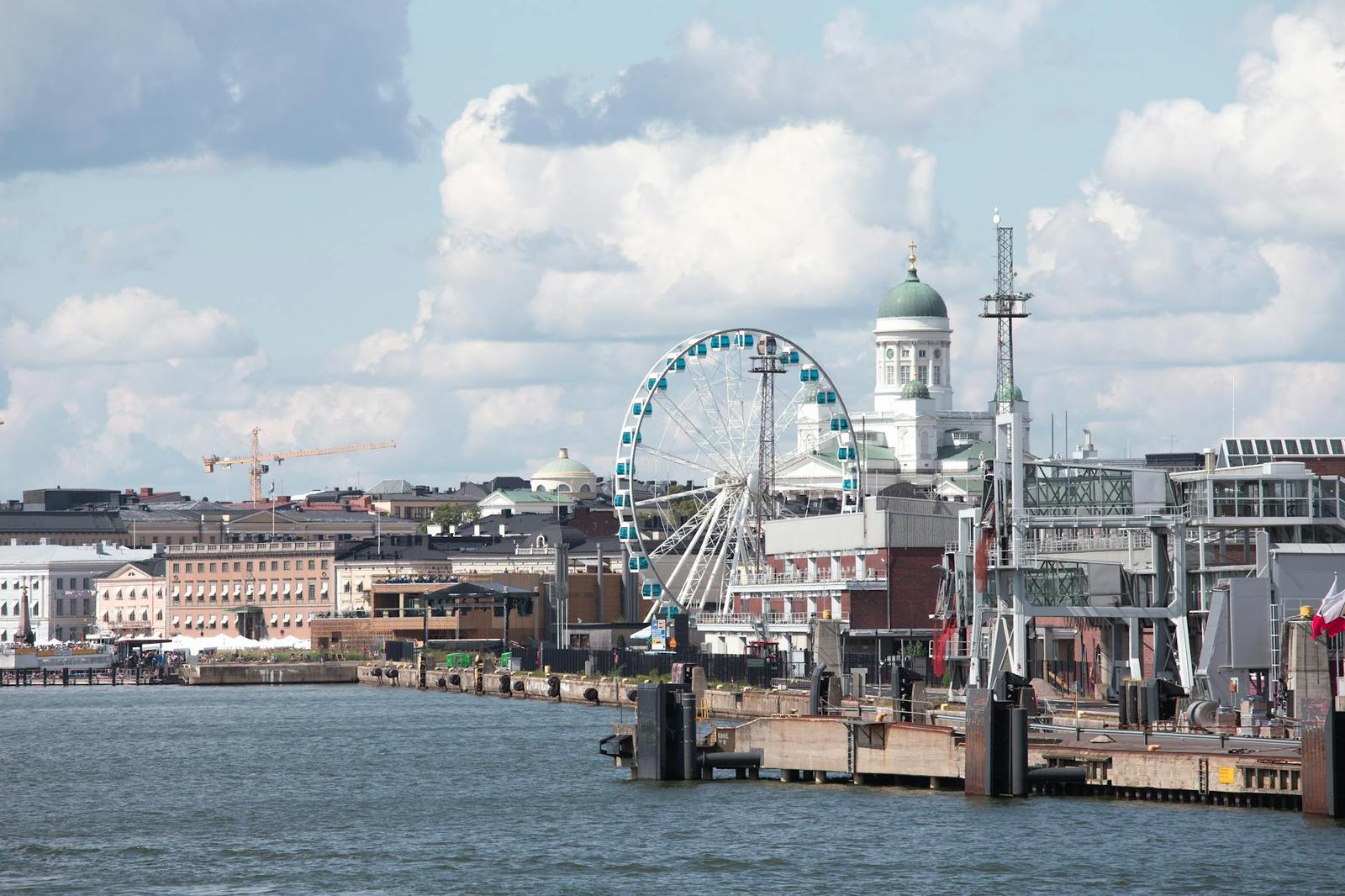 Scenic Helsinki waterfront featuring the Sky Wheel and iconic Helsinki Cathedral