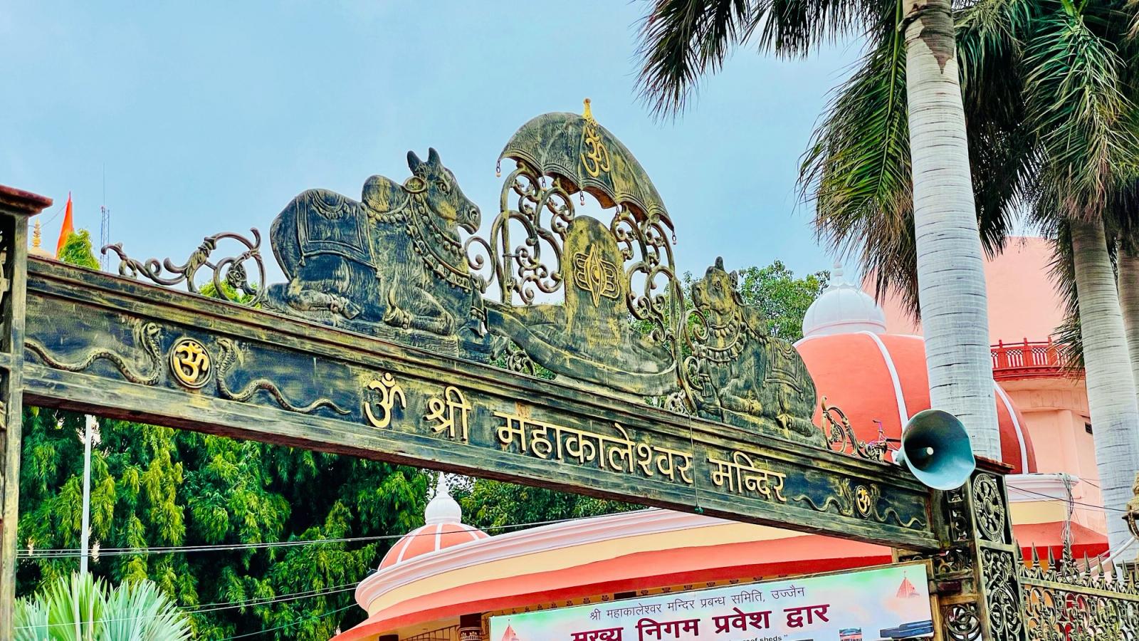 a sign with a statue on it Mahakaleshwar Jyotirlinga is a Hindu temple dedicated to Shiva and is one of the tw