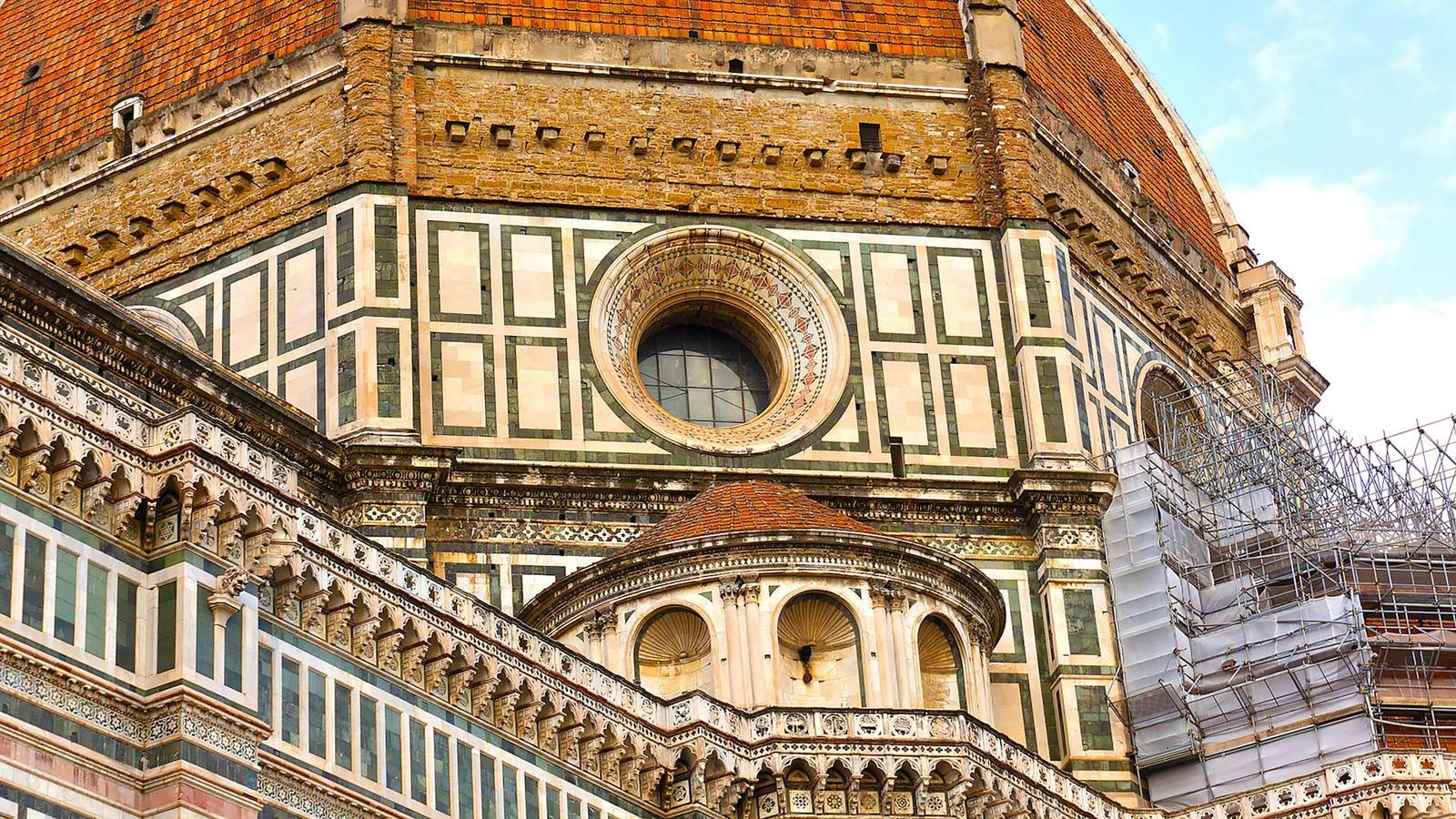 Close-up of a marble-patterned cathedral dome and circular window