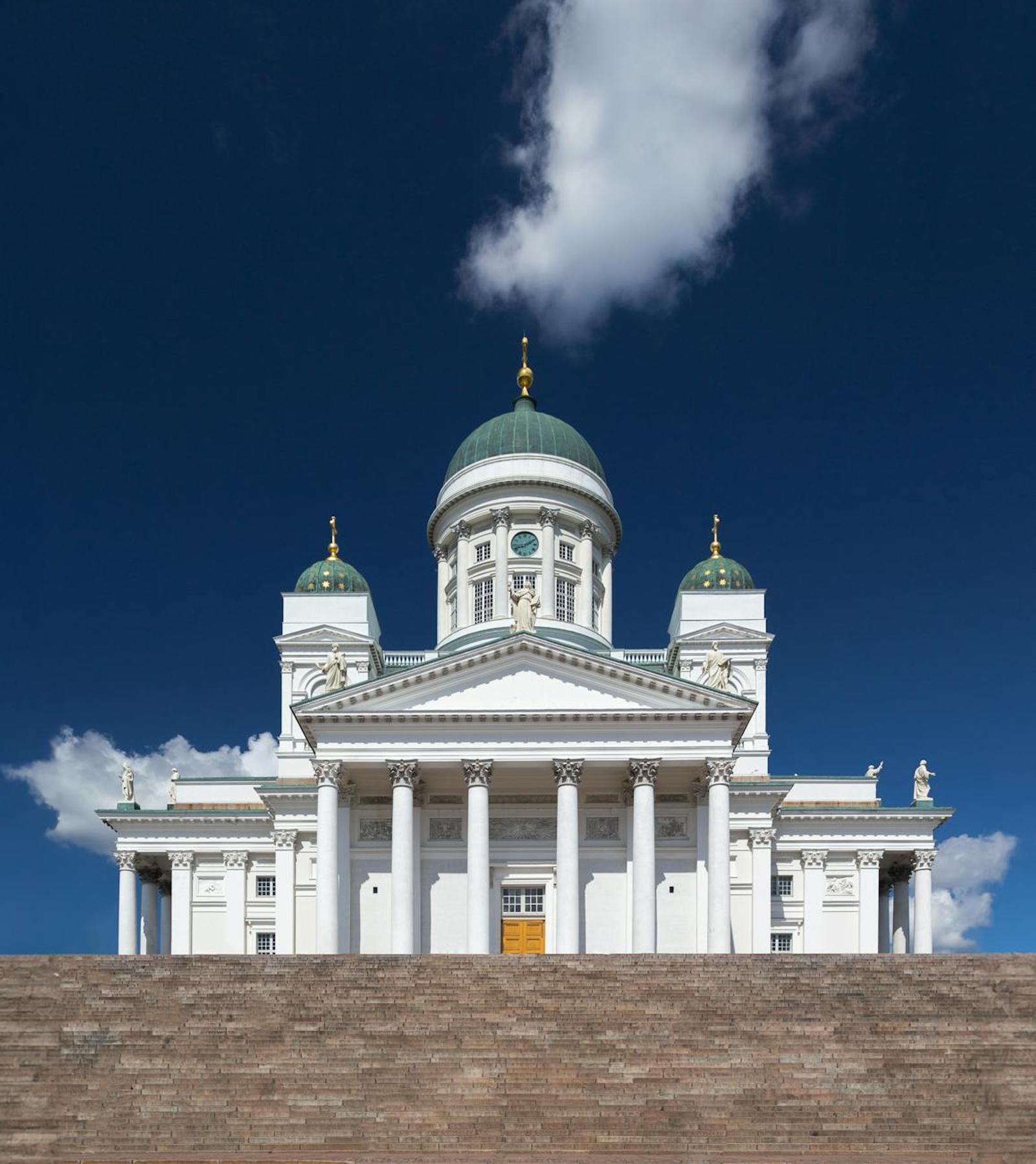 Explore the majestic neoclassical architecture of Helsinki Cathedral under a bright blue sky