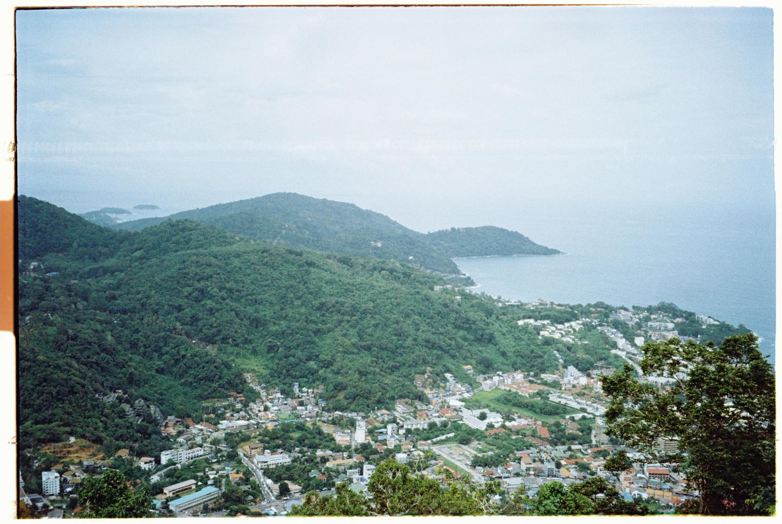 Stunning aerial view of lush greenery, coastal landscape, and townscape in Phuket, Thailand
