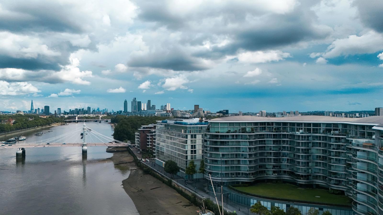 Aerial view of London's riverfront with modern architecture and city skyline