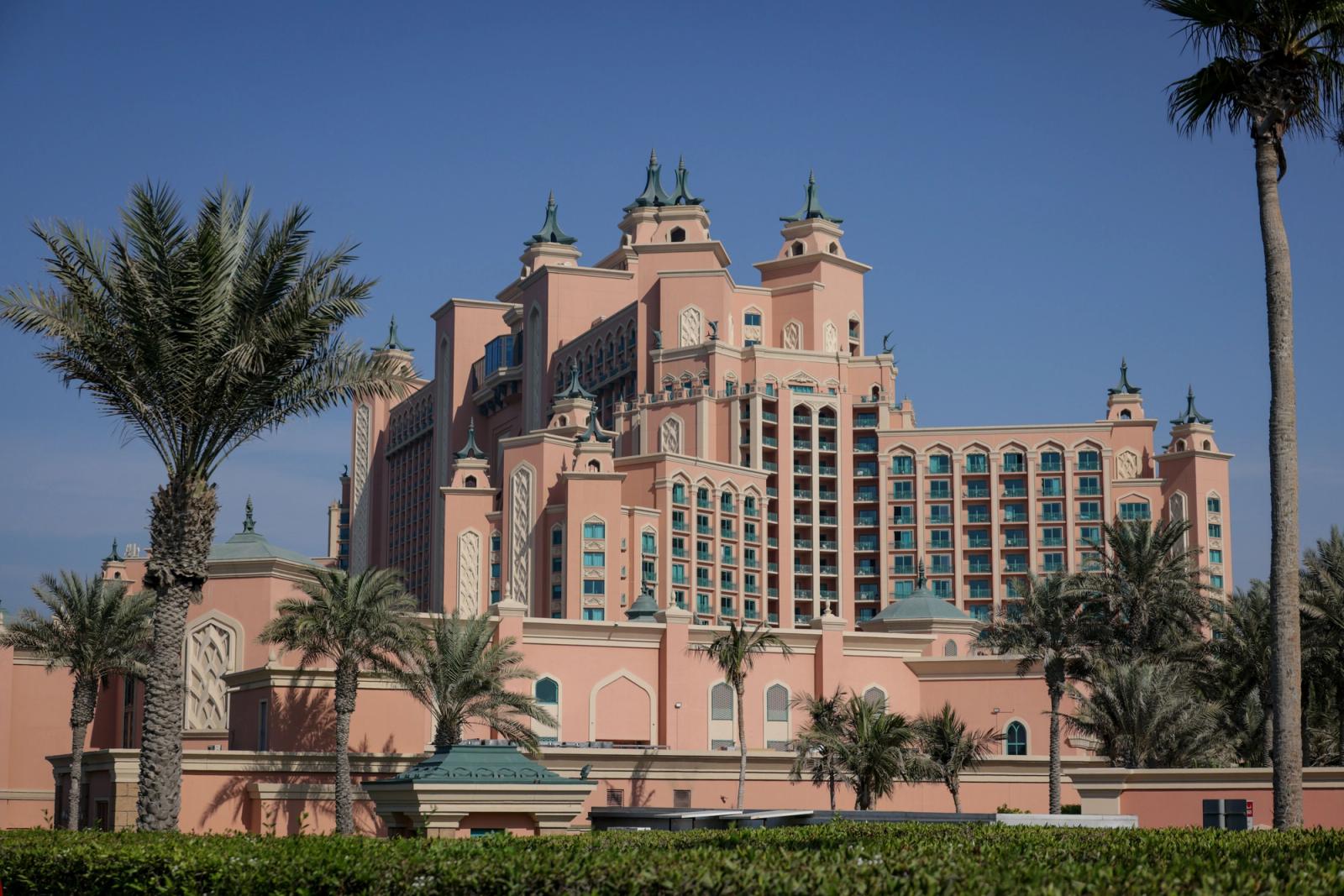 Elegant view of the Atlantis Hotel in Dubai with palm trees under a clear blue sky