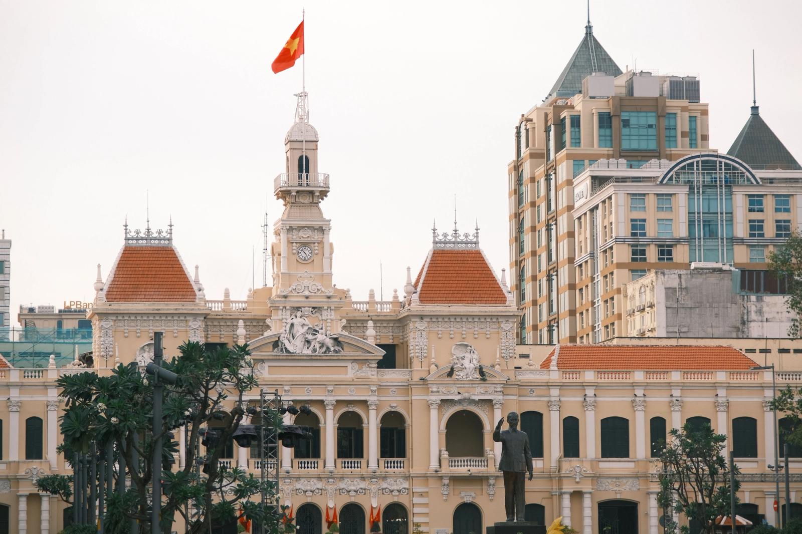 Majestic view of Saigon City Hall with Vietnamese flag in Ho Chi Minh City