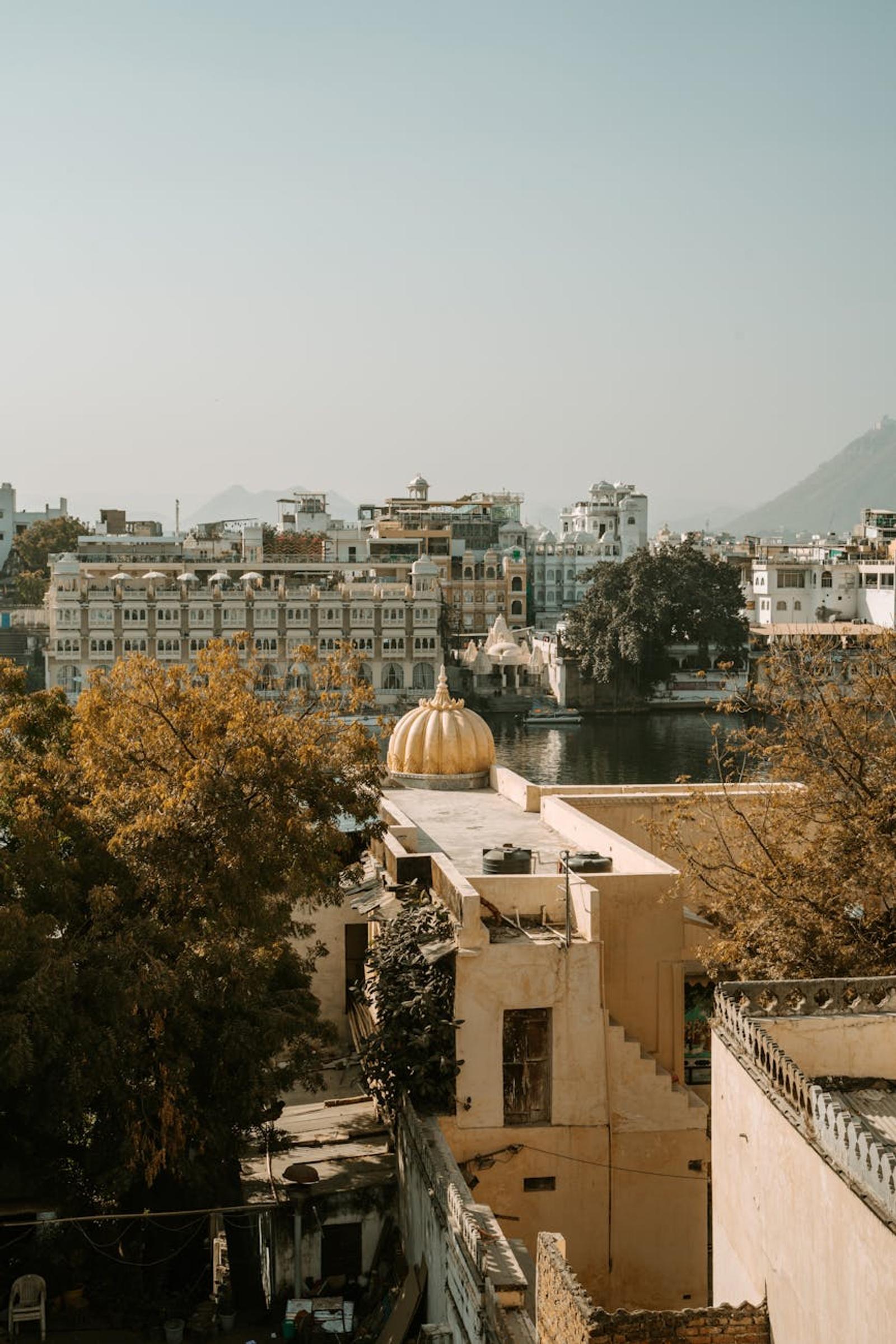 A picturesque view of Udaipur city with traditional architecture and a tranquil lake