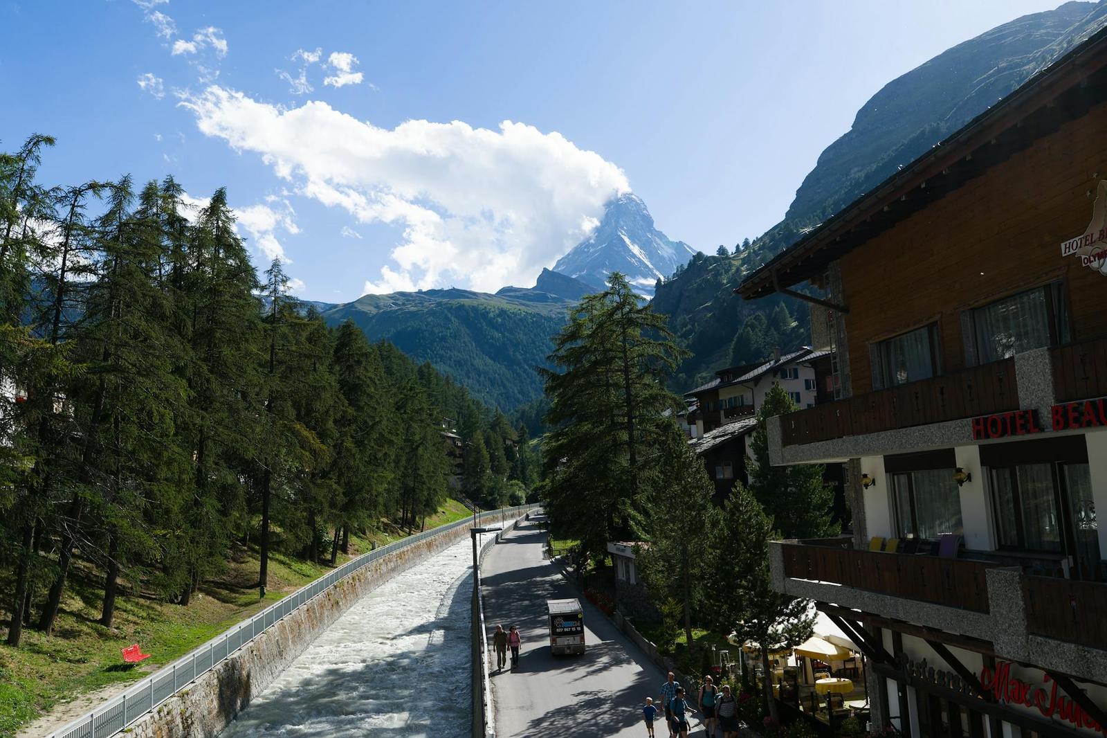 Mountain village street with a pyramid peak rising above the treeline