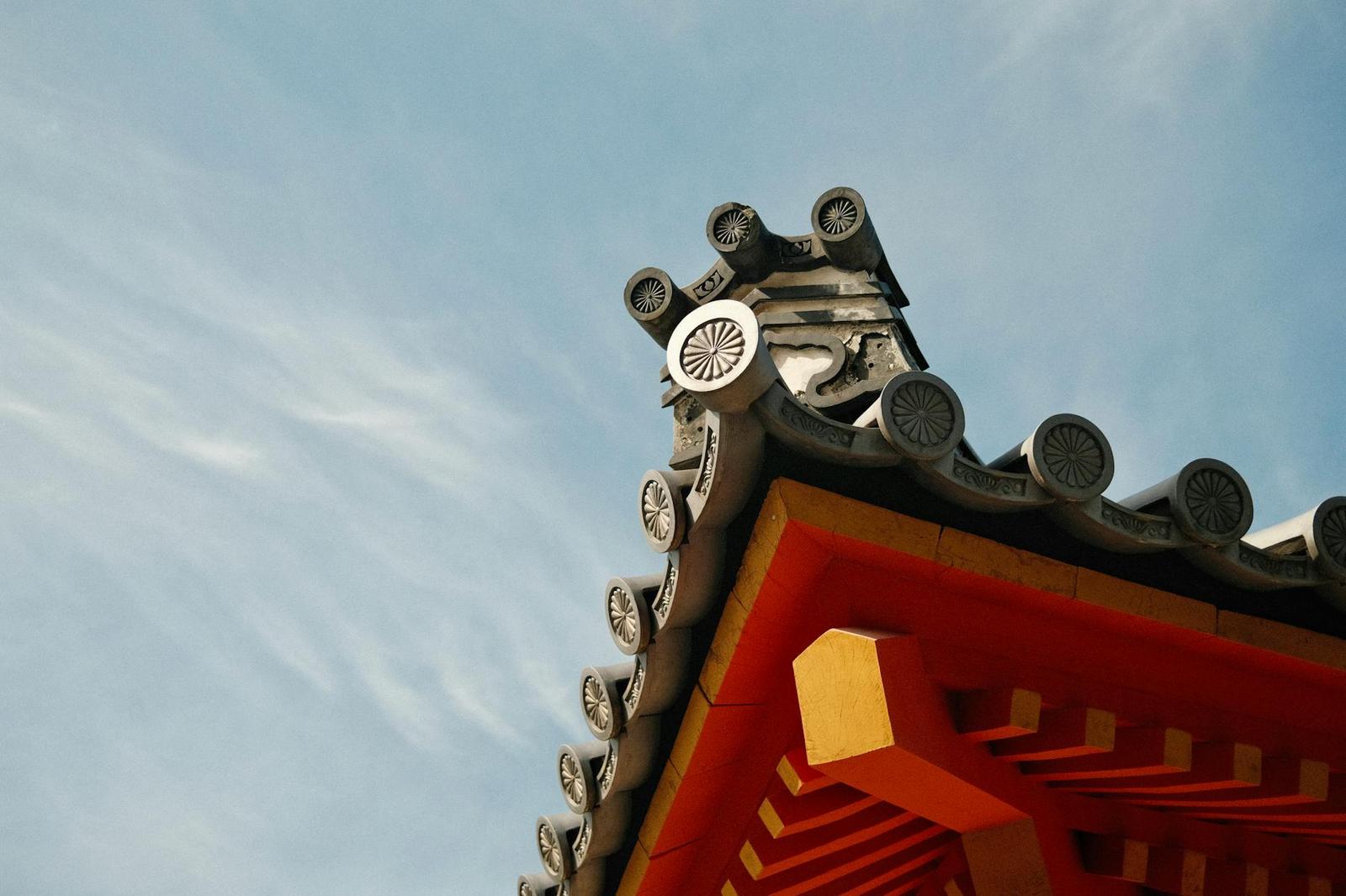 Detailed view of a traditional Japanese temple roof in Kyoto with decorative elements