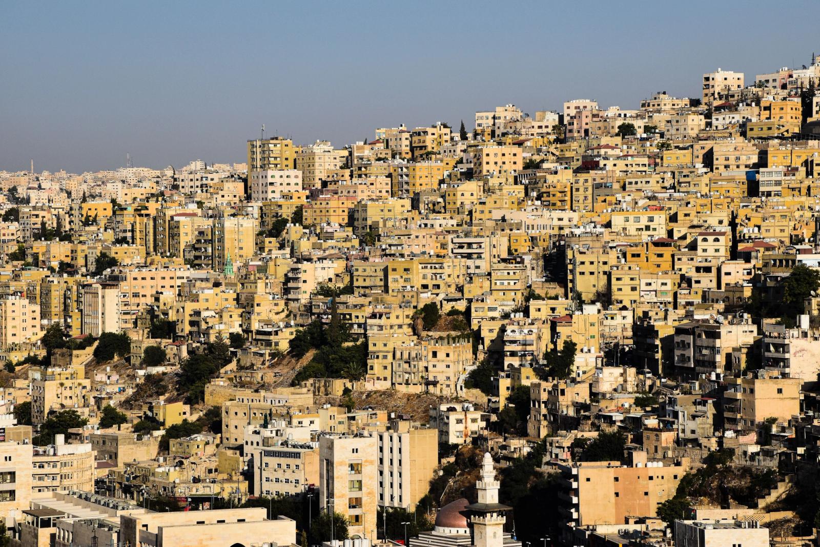 Densely packed urban buildings in Amman, Jordan captured from above, showcasing cityscape