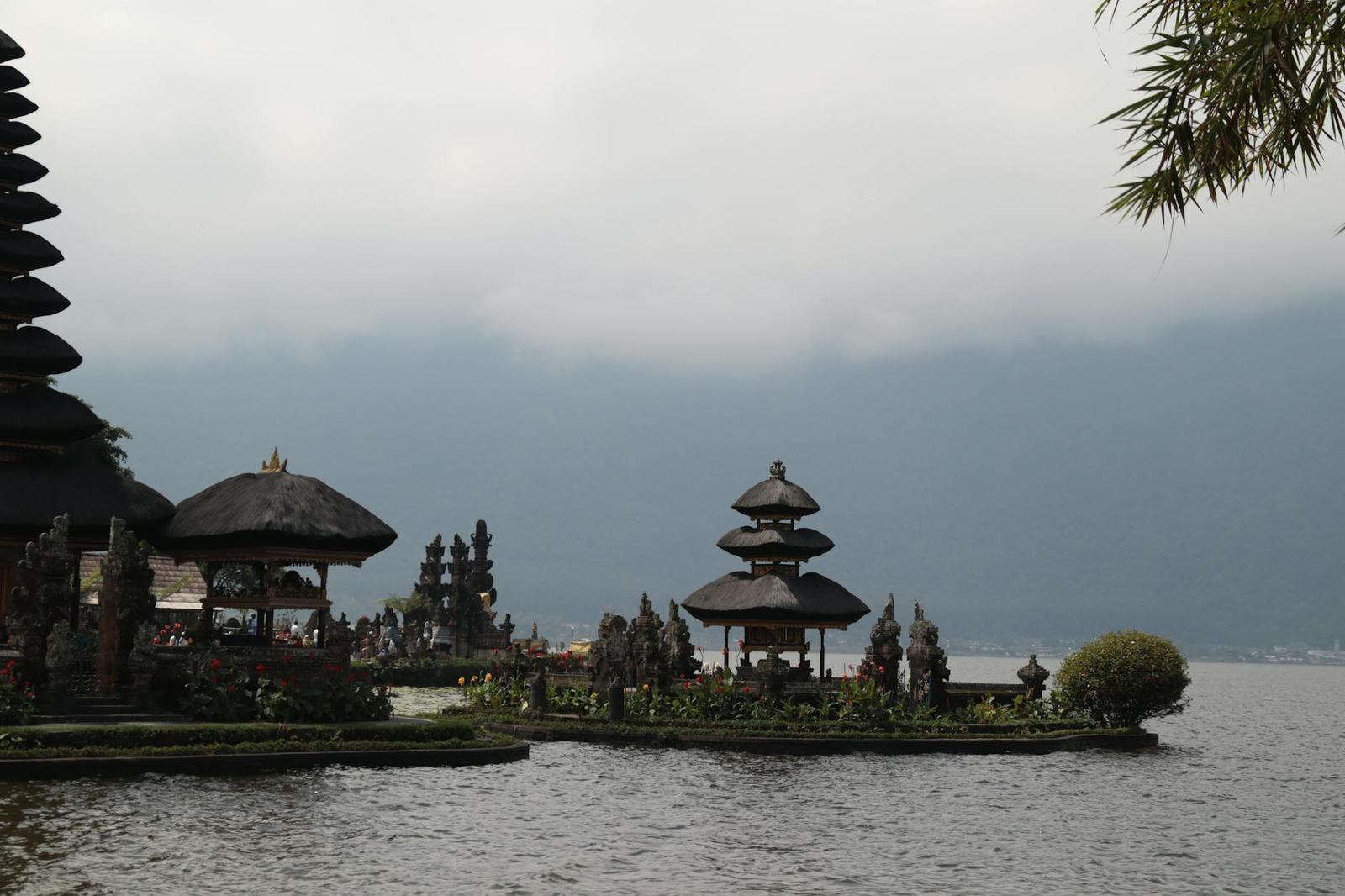 Elegant shot of Ulun Danu Beratan Temple against serene lake and mountains in Bali, Indonesia