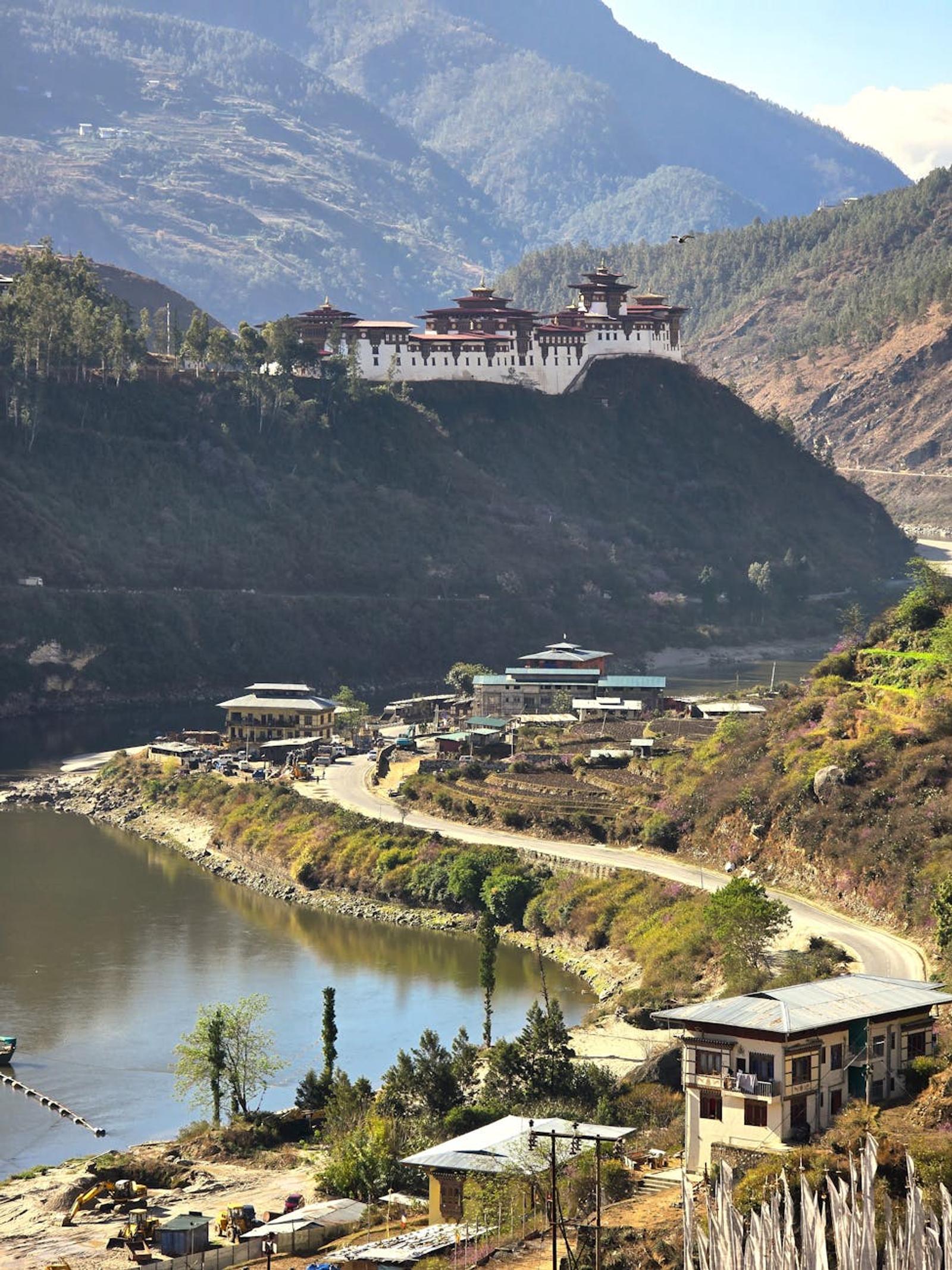 A beautiful aerial view of Punakha Dzong with a river and mountains in the background