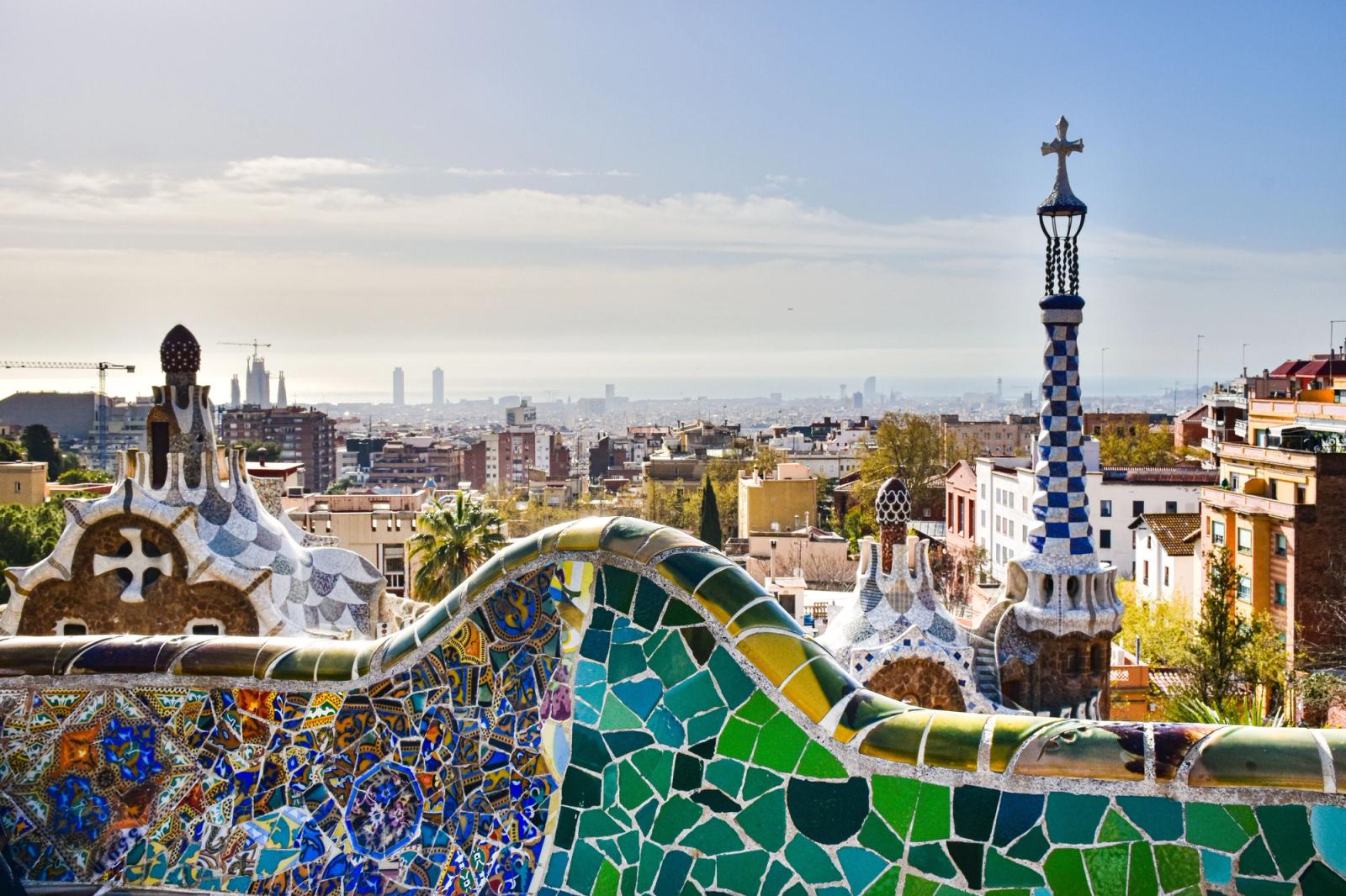 View of Barcelona from Park Güell showcasing mosaic architecture and city skyline
