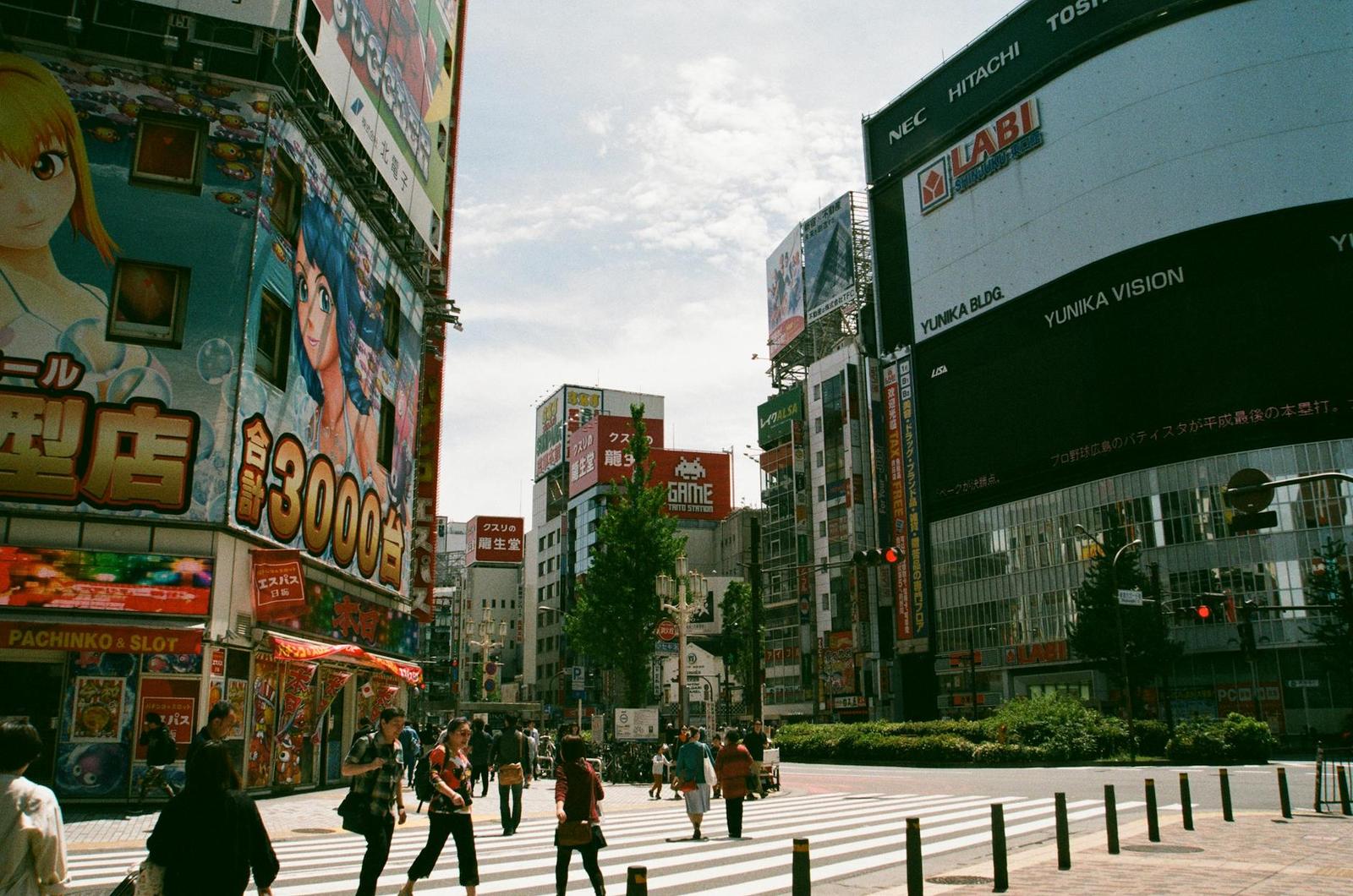 Bustling urban street in Shinjuku, Tokyo showcasing Japanese culture and vibrant billboards