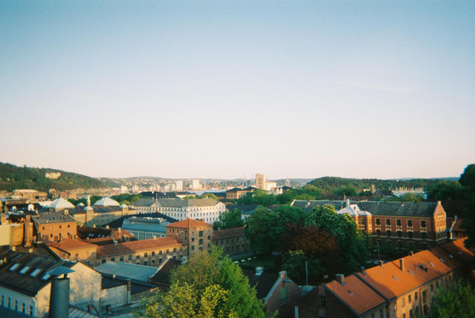 City skyline of red rooftops and hills seen from an elevated viewpoint