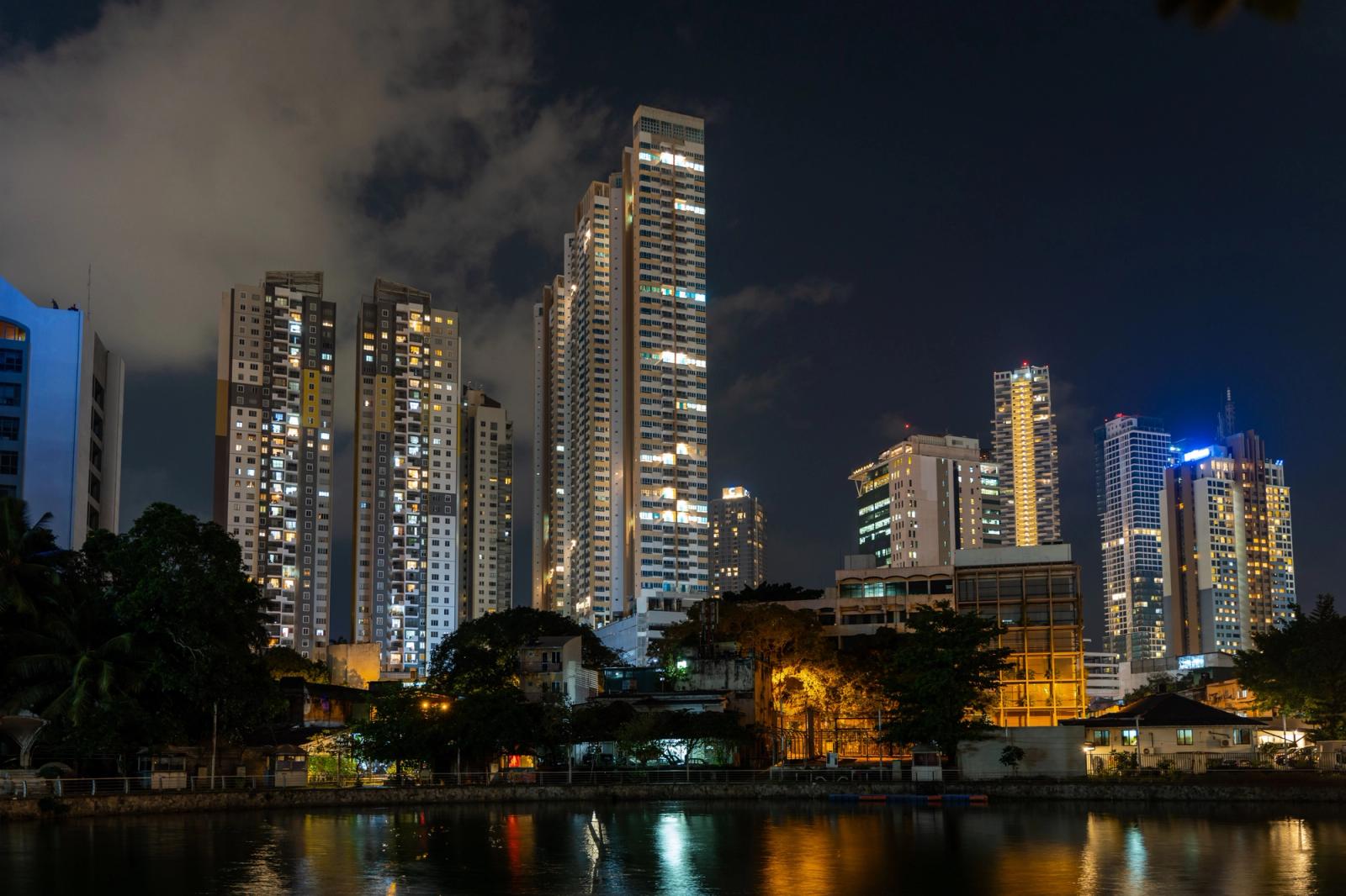 Dazzling night view of Colombo's modern skyline reflecting on a tranquil waterfront