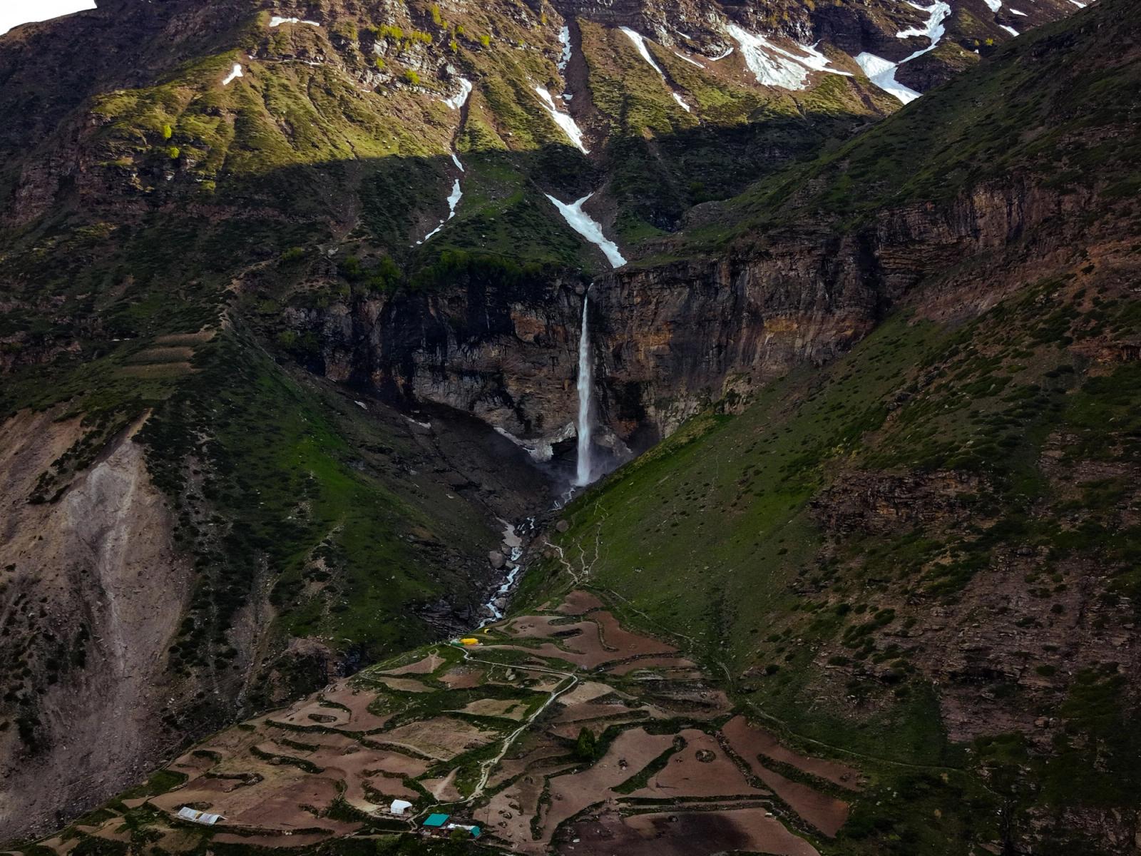 A breathtaking view of a waterfall cascading down a mountain in Sissu, Himachal Pradesh, India