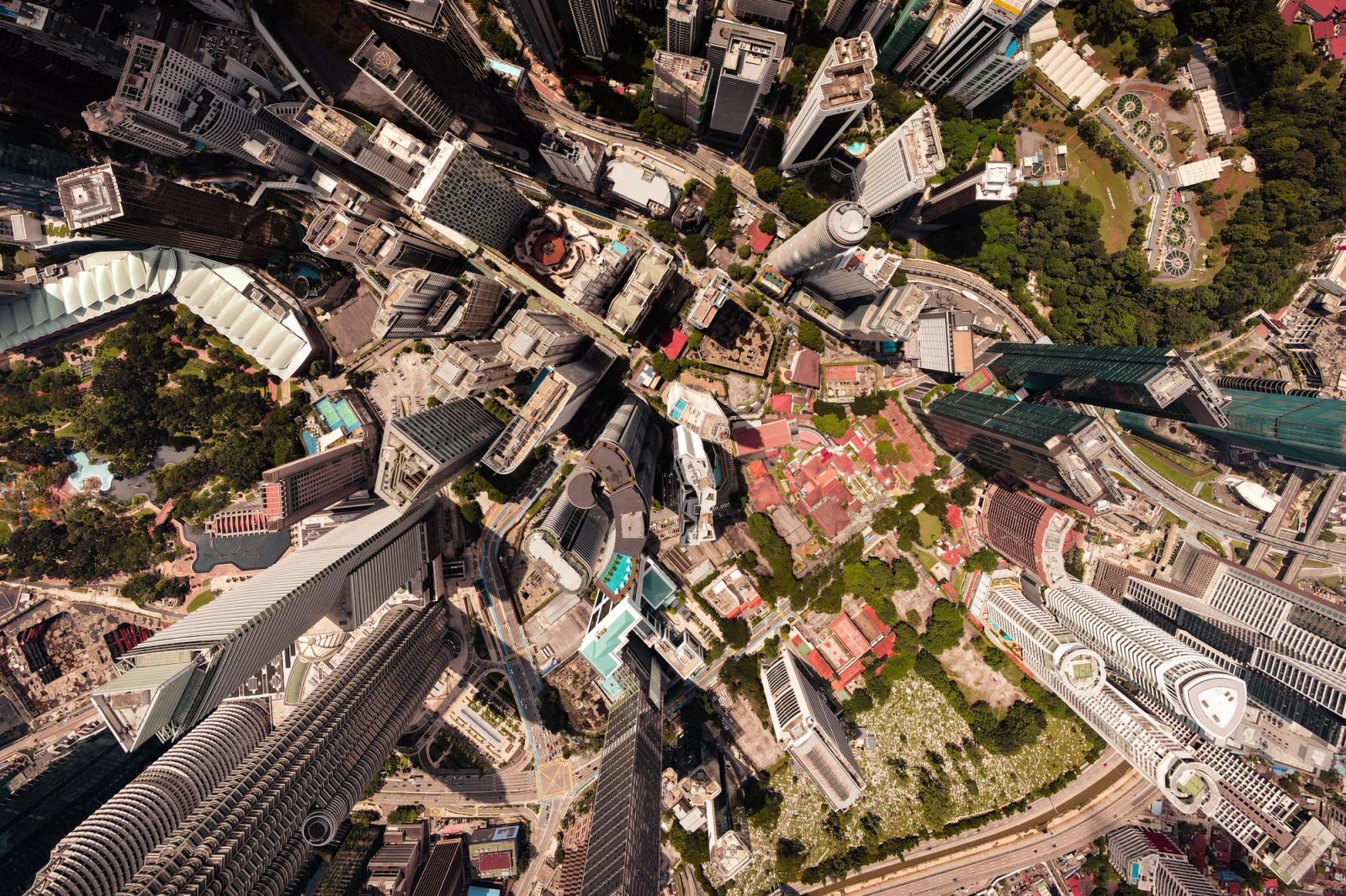 A breathtaking aerial view of a vibrant cityscape filled with towering skyscrapers and lush greenery