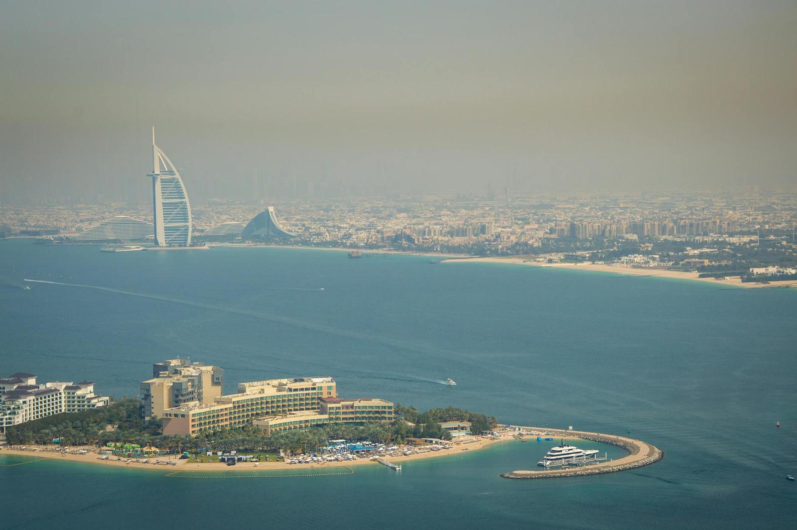 Aerial view of the sail-shaped Burj Al Arab hotel on its coastal peninsula