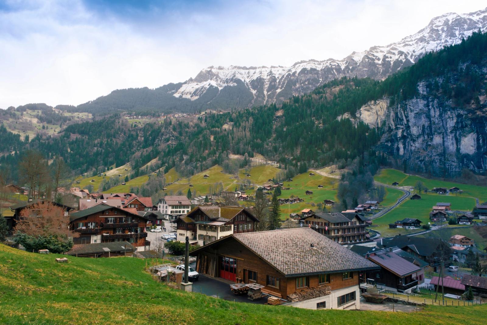 Explore the picturesque village of Lauterbrunnen in Switzerland, surrounded by stunning alpine scenery and lush greenery