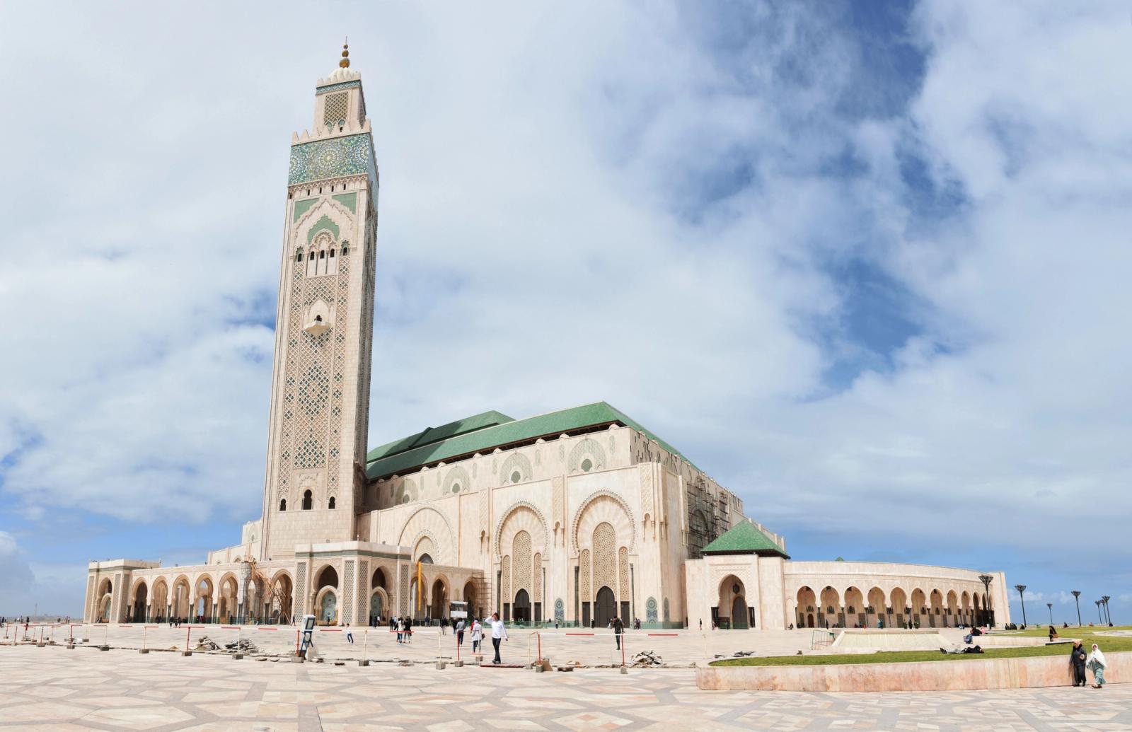 The iconic Hassan II Mosque in Casablanca under a blue sky, a key architectural masterpiece