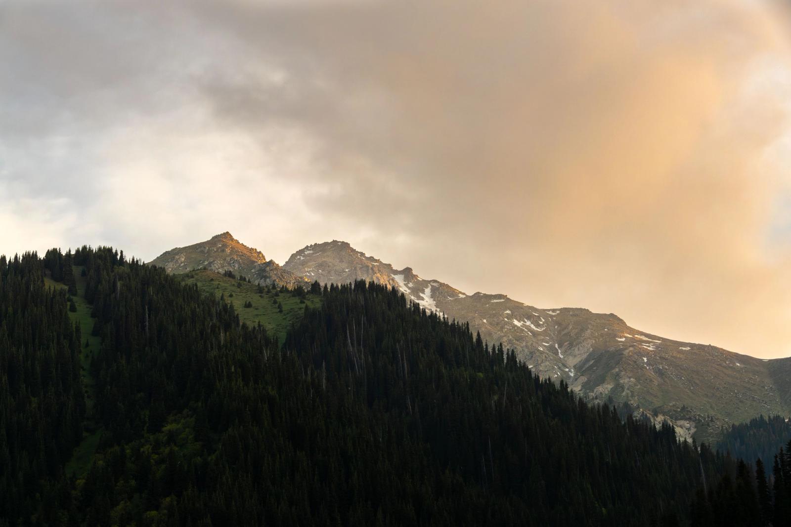 Captivating sunrise over snow-capped mountains in Almaty, showcasing nature's beauty