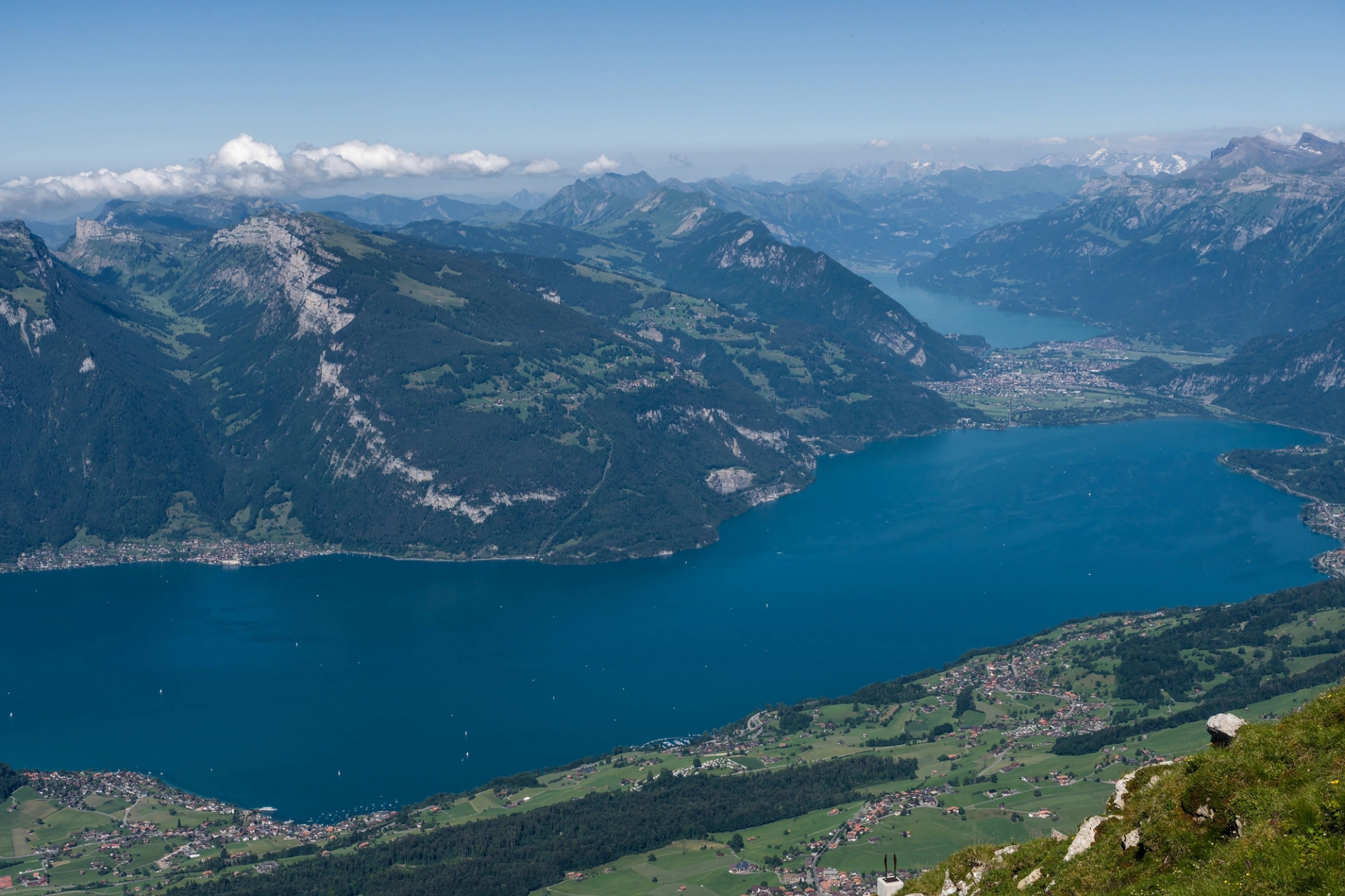 Breathtaking aerial view of Lake Lucerne amidst the majestic Swiss Alps on a clear summer day