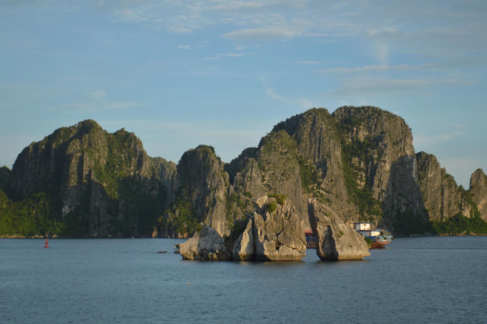 Scenic view of limestone karsts in Halong Bay under a clear blue sky