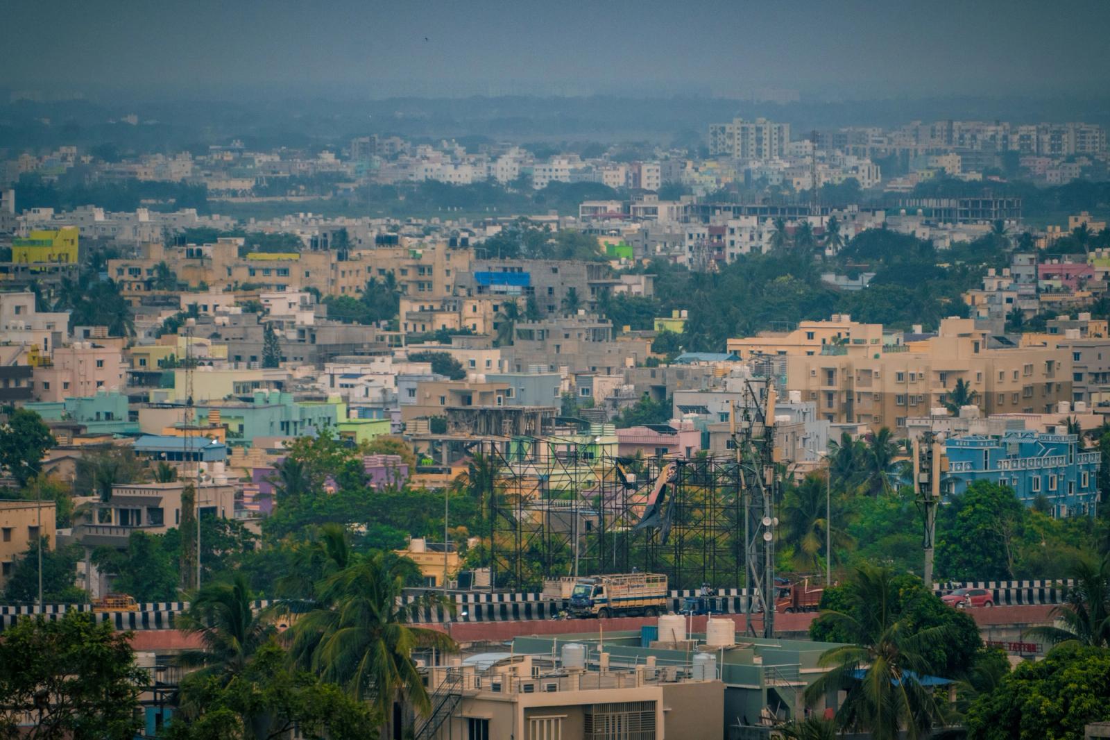 Aerial view of Bhubaneswar's colorful buildings and lush greenery, showcasing urban life in India