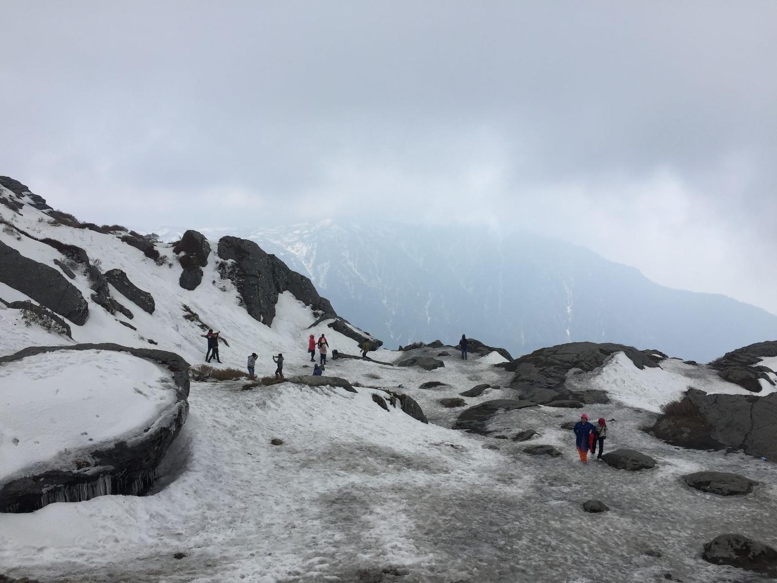 Hikers enjoy breathtaking views on a snow-covered mountain in Gangtok, India
