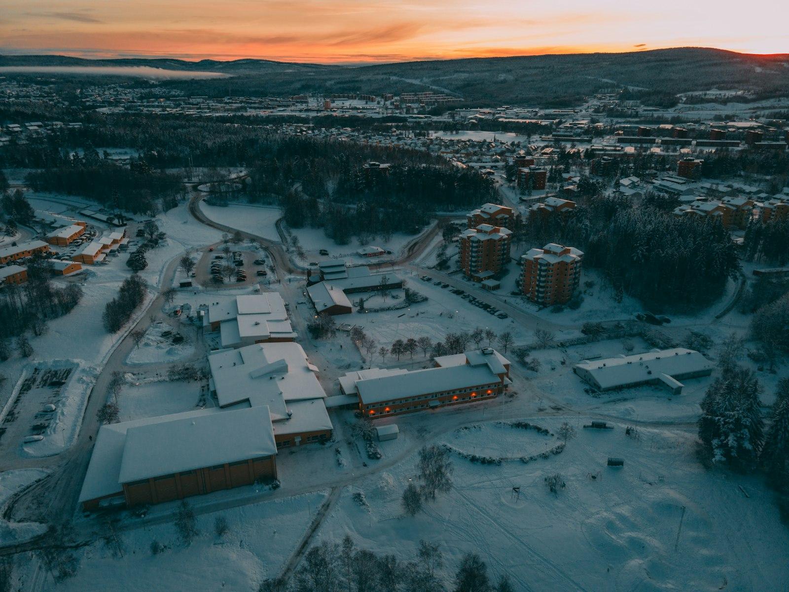 A snowbound Lapland resort village from the air at sunset