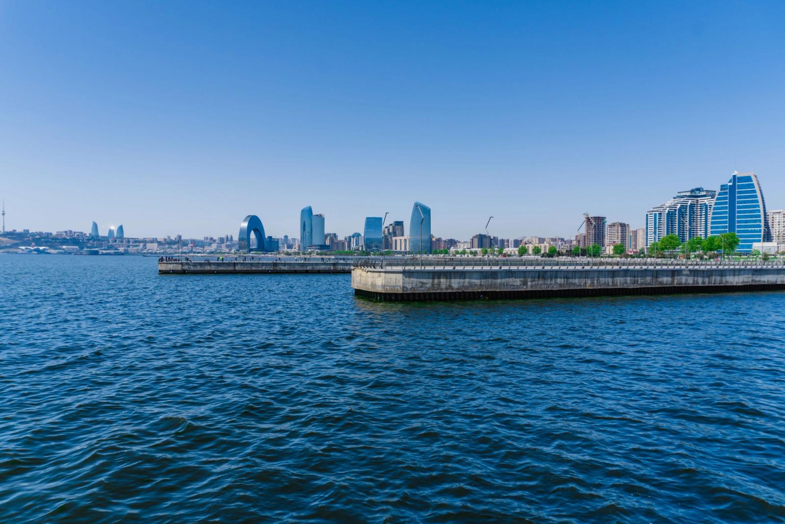 Stunning view of Baku's skyline from the Caspian Sea, featuring modern architecture and clear blue sky