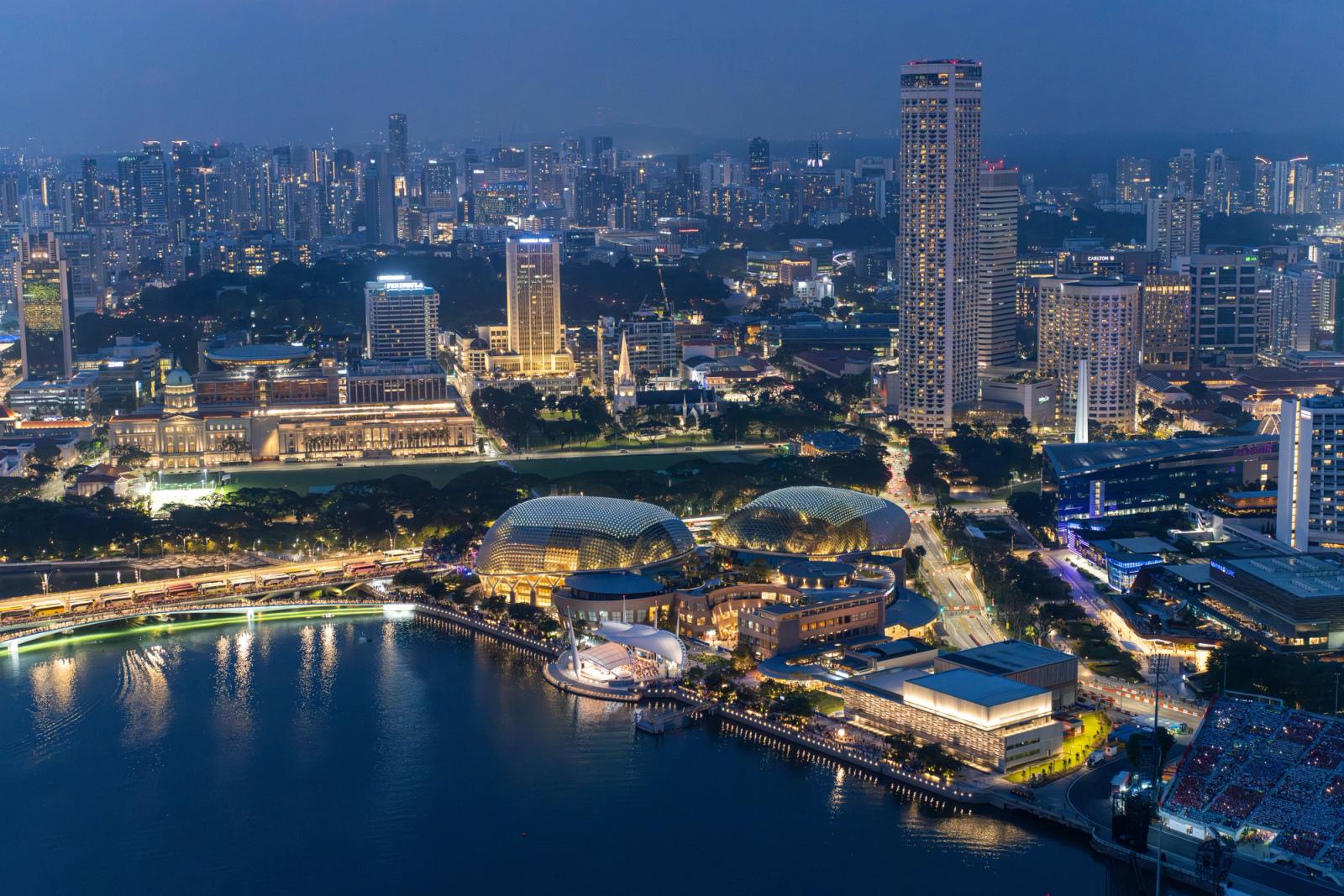 Captivating aerial view of Singapore's illuminated skyline and Marina Bay at night