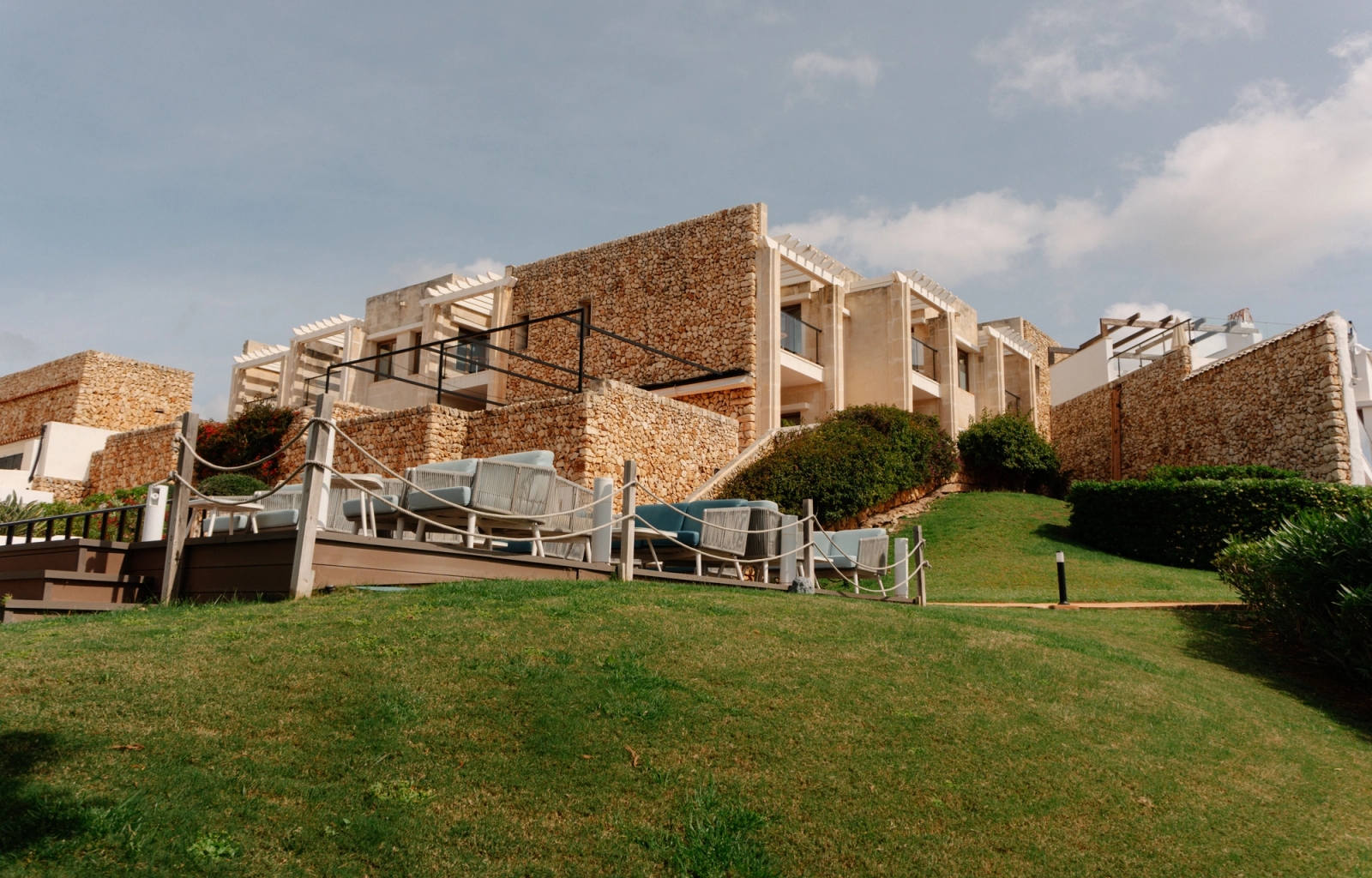 Stunning view of modern hotel architecture set against a green landscape in Ciutadella de Menorca