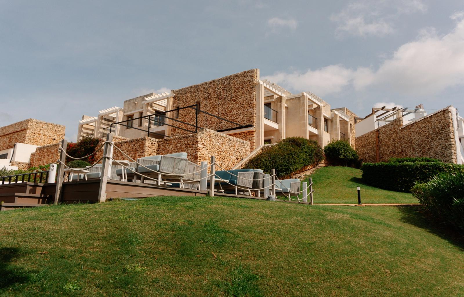 Stunning view of modern hotel architecture set against a green landscape in Ciutadella de Menorca