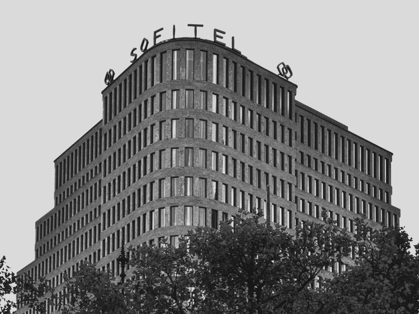 Black and white photo of Sofitel Hotel's modern facade in Berlin, Germany