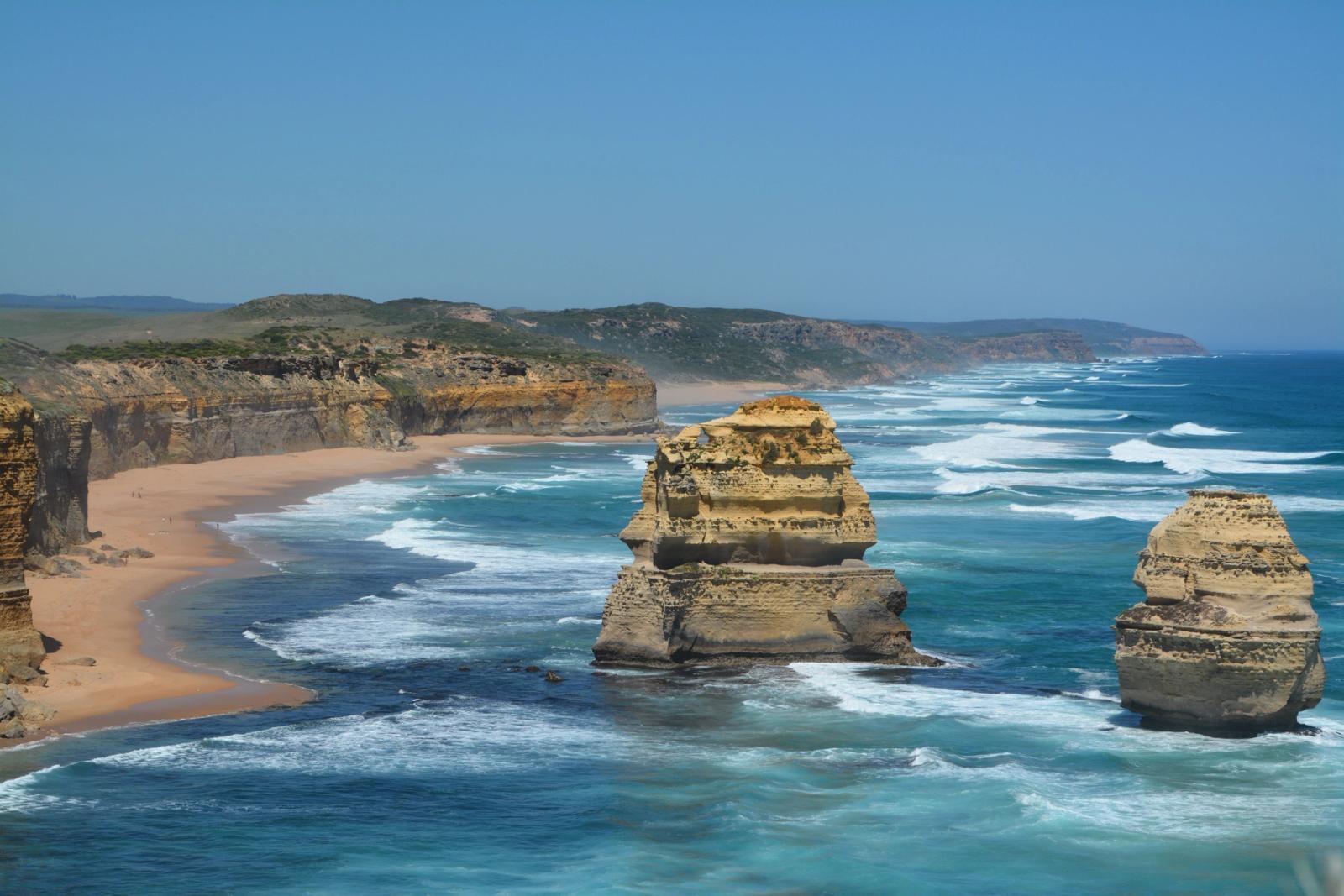 Rugged coastal cliffs with limestone sea stacks rising from turquoise waves