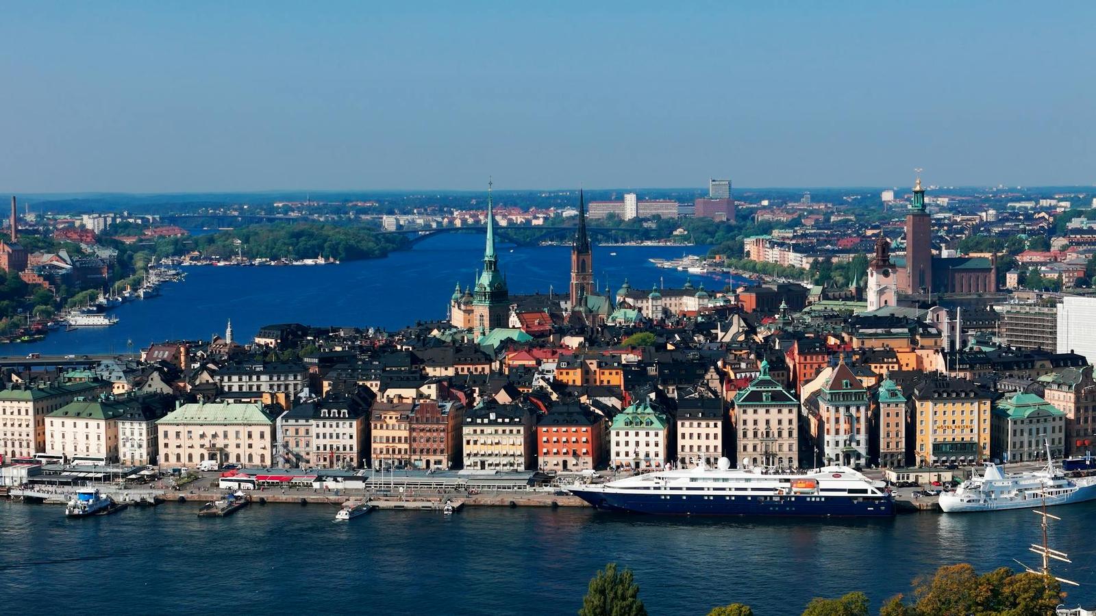 Aerial view of a historic waterfront city with a docked cruise ship