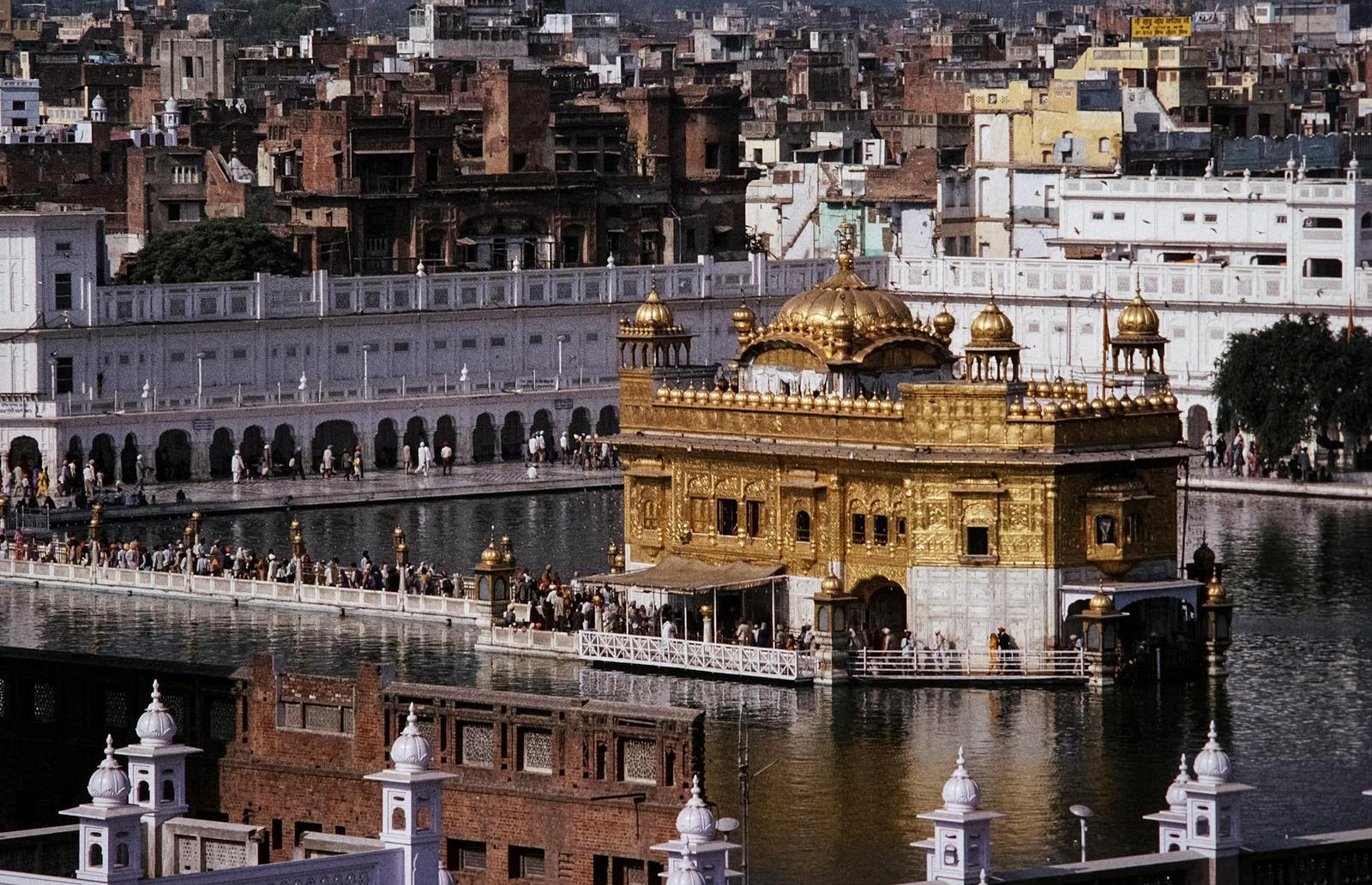 A gilded temple shrine reflected in its surrounding lake
