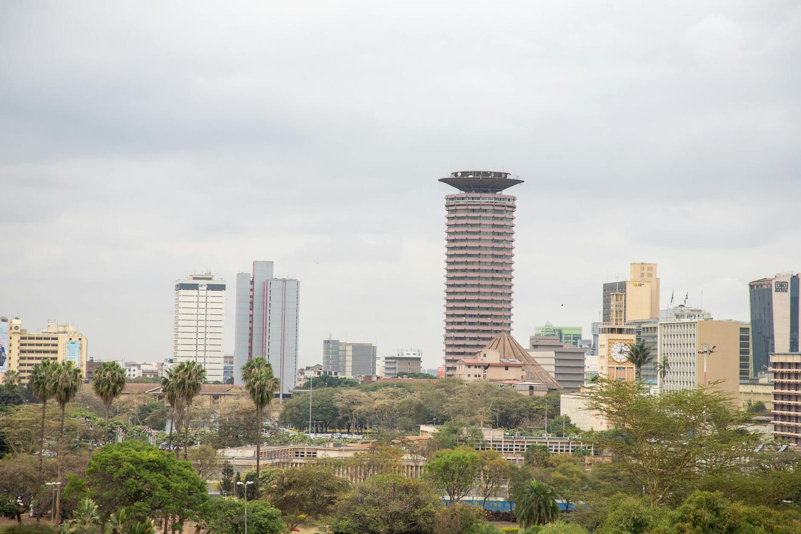 View of Nairobi's skyline with the iconic KICC tower and surrounding high rises under a cloudy sky